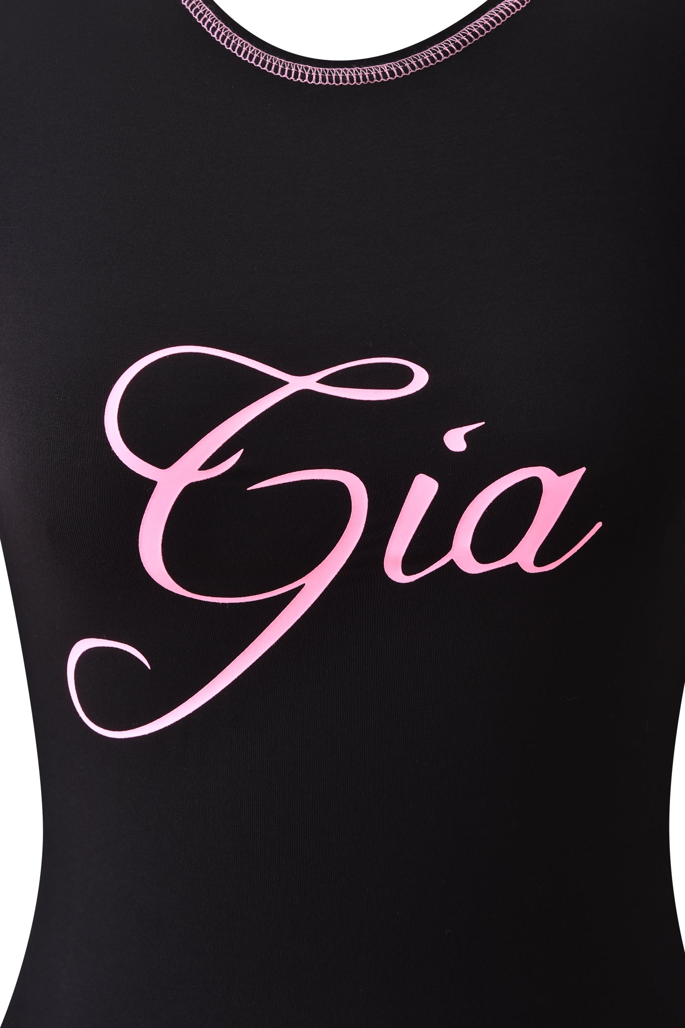 The I.AM.GIA BLARE LONG SLEEVE TOP - BLACK features bold black fabric with "Gia" displayed in large, elegant light pink script, making a stylish statement.