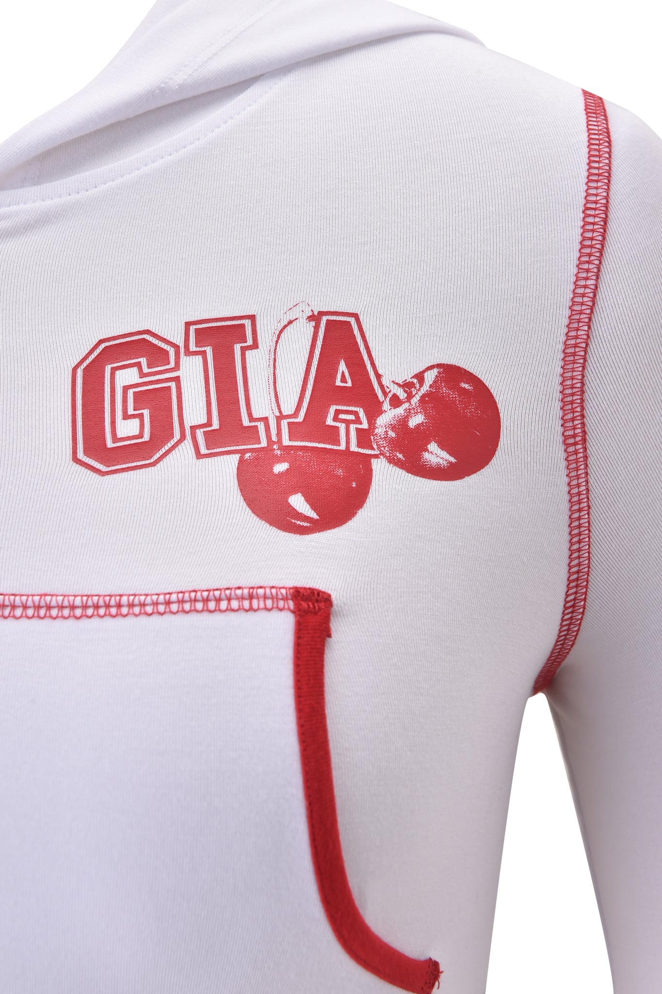 Close-up of the BLARE CROPPED HOODIE - WHITE by I.AM.GIA, featuring red stitching, a hood, pocket, and bold “GIA” text with two red cherry graphics on the chest.