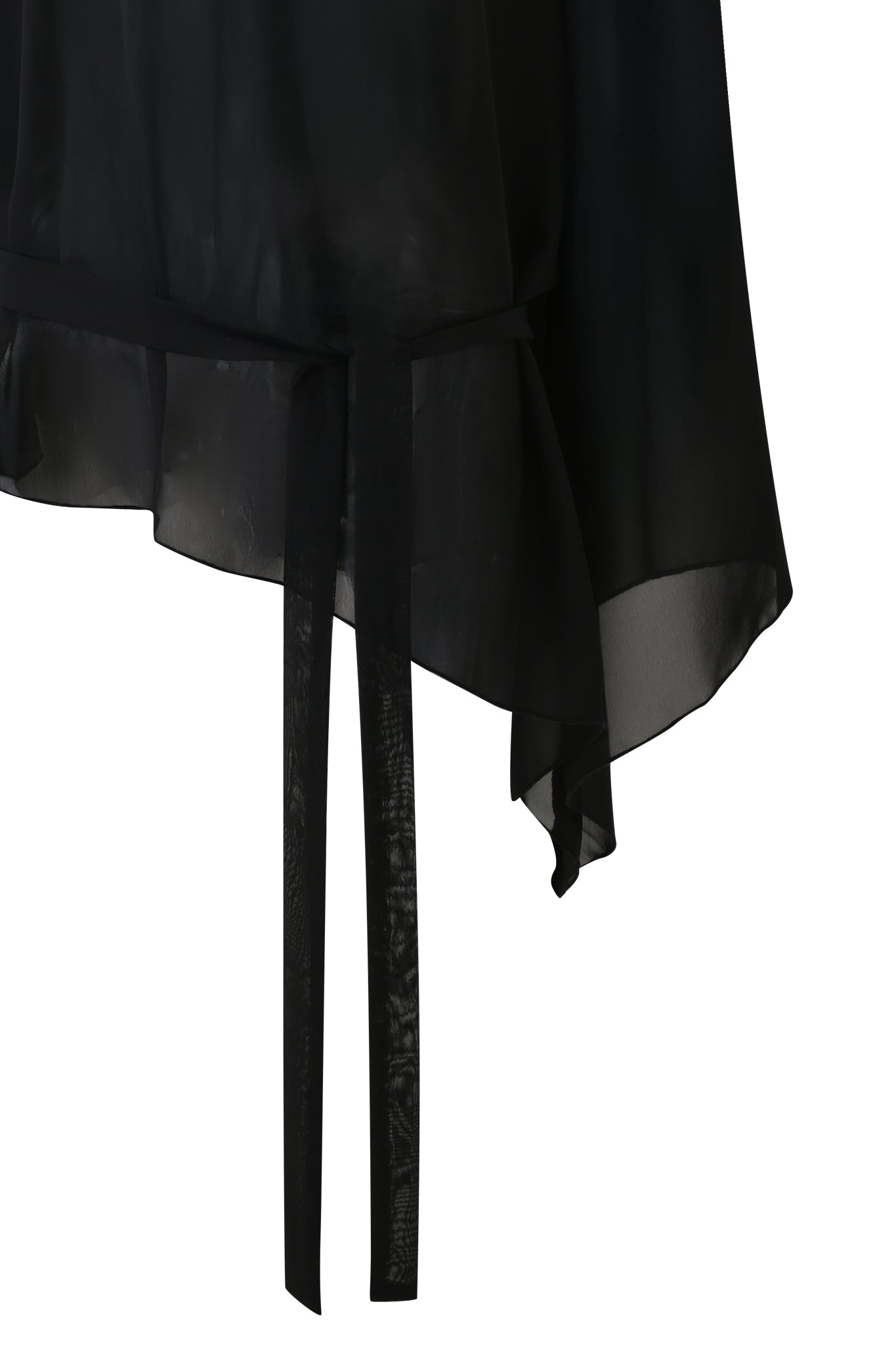 A close-up of the MALINA LONG SLEEVE PONCHO TOP by I.AM.GIA, a black sheer off-the-shoulder style with an asymmetrical hem and a matching fabric belt at the waist.