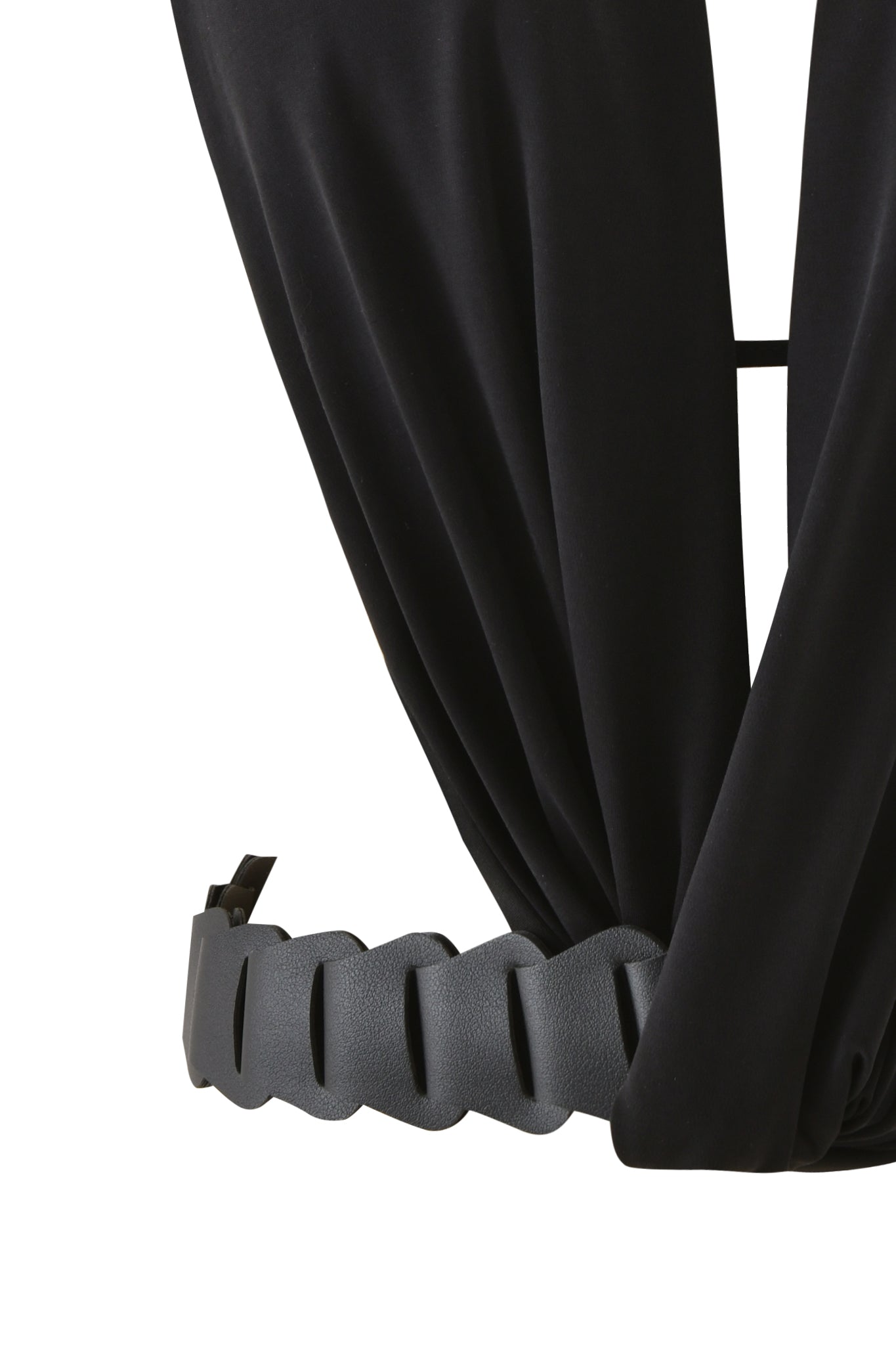 Close-up of the SALDANA TOP - BLACK by I.AM.GIA, showcasing draped black fabric and a wide, wavy-edged faux leather belt with a rectangular buckle and adjustable strap.