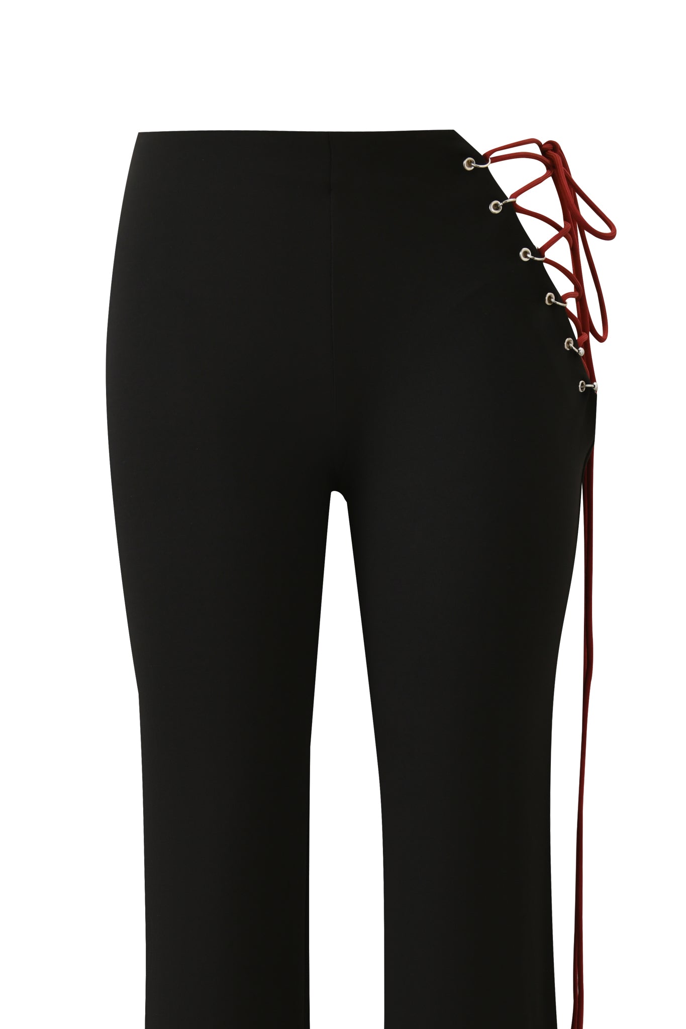 The ONYX PANT - BLACK by I.AM.GIA features a fitted silhouette with red lace-up ties threaded through silver eyelets at the upper right hip, all in smooth sueded jersey fabric for a modern look.