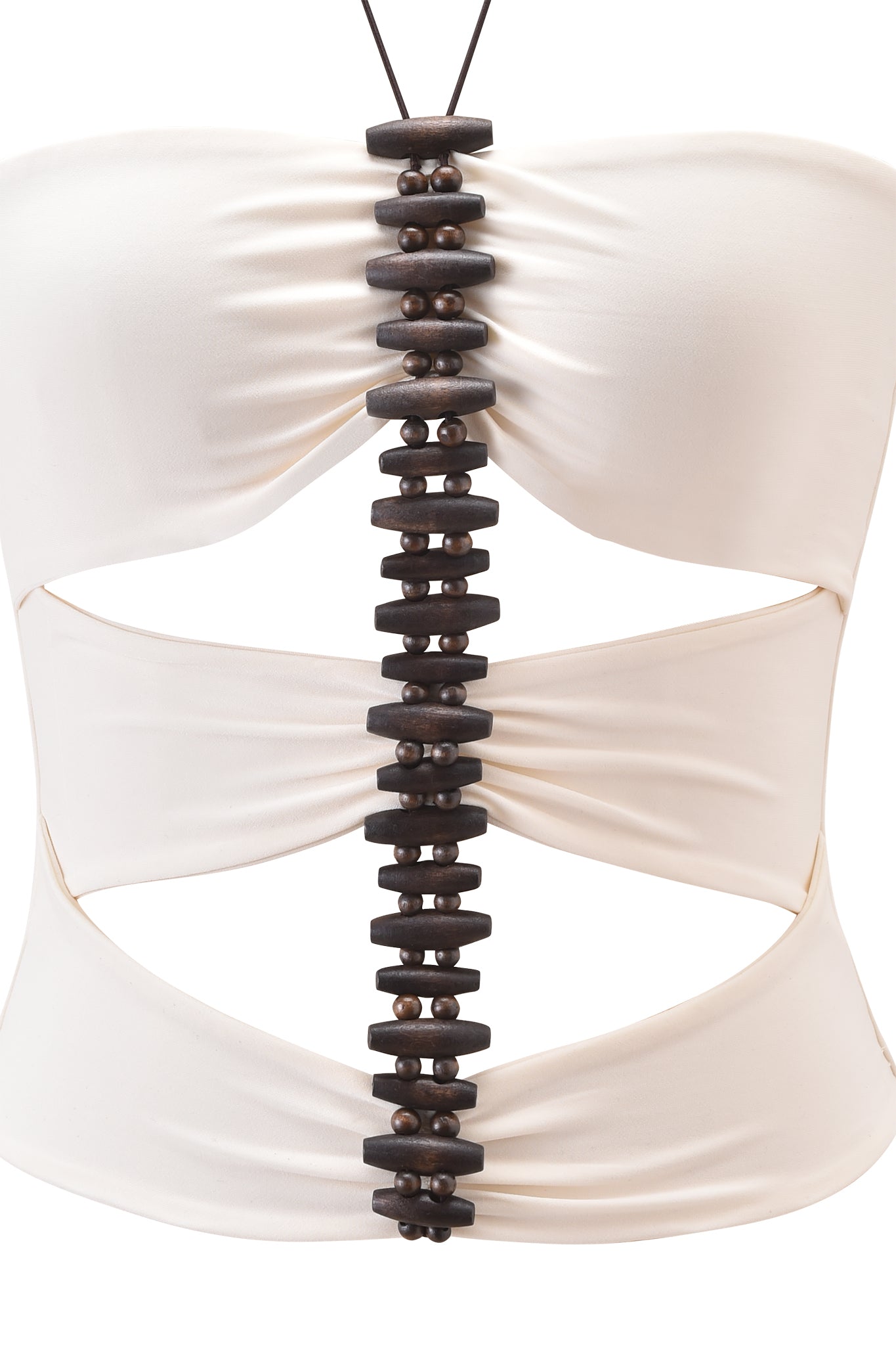 A close-up of the I.AM.GIA FENNICK TOP in off white, a strapless bodycon piece with cut-out sides and a central vertical strip of dark wooden beads and discs.