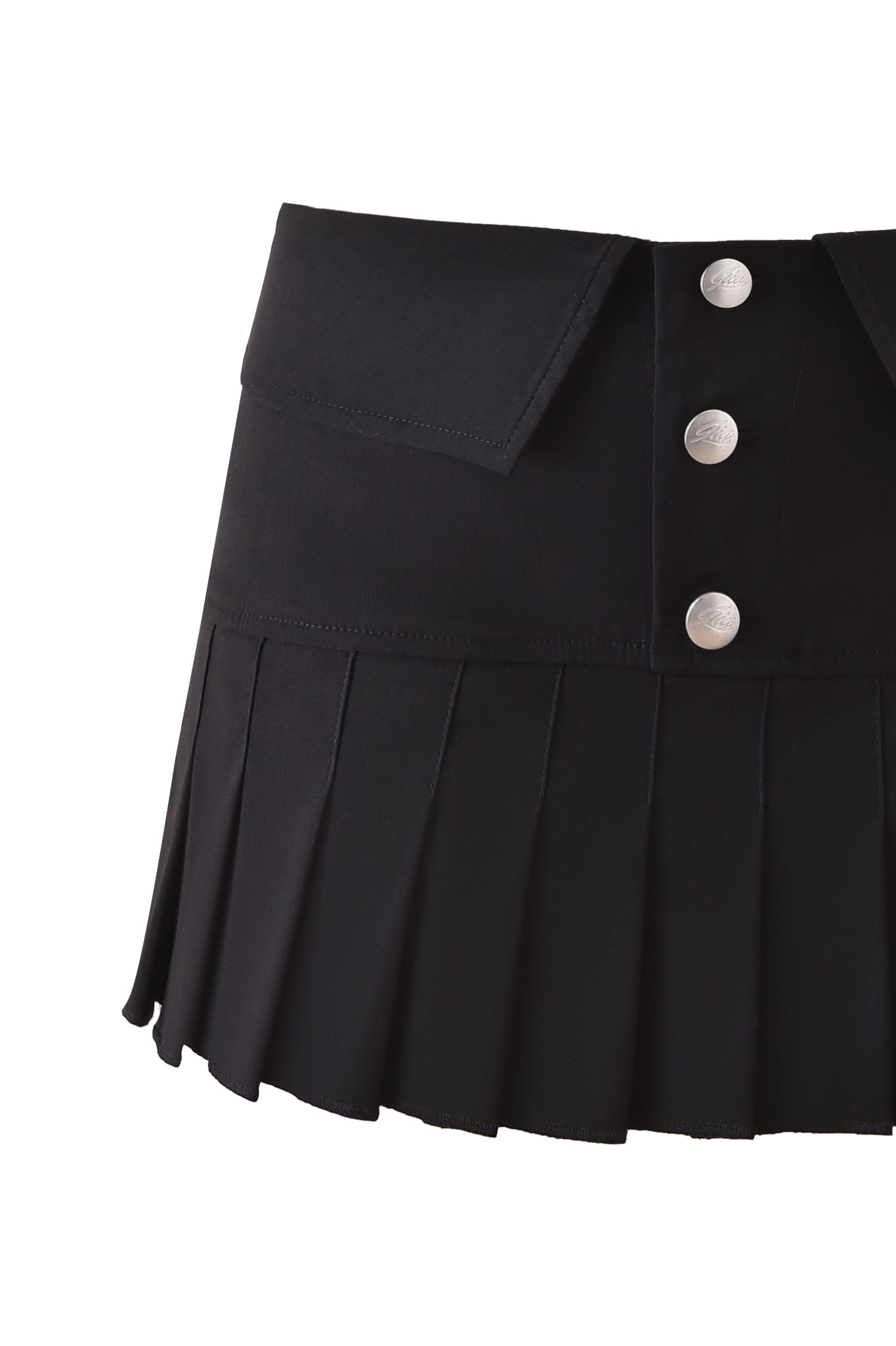 The BLAKE MINI SKORT - BLACK by I.AM.GIA features pleats, silver buttons, and a flap detail on a wide waistband, shown against a white background.
