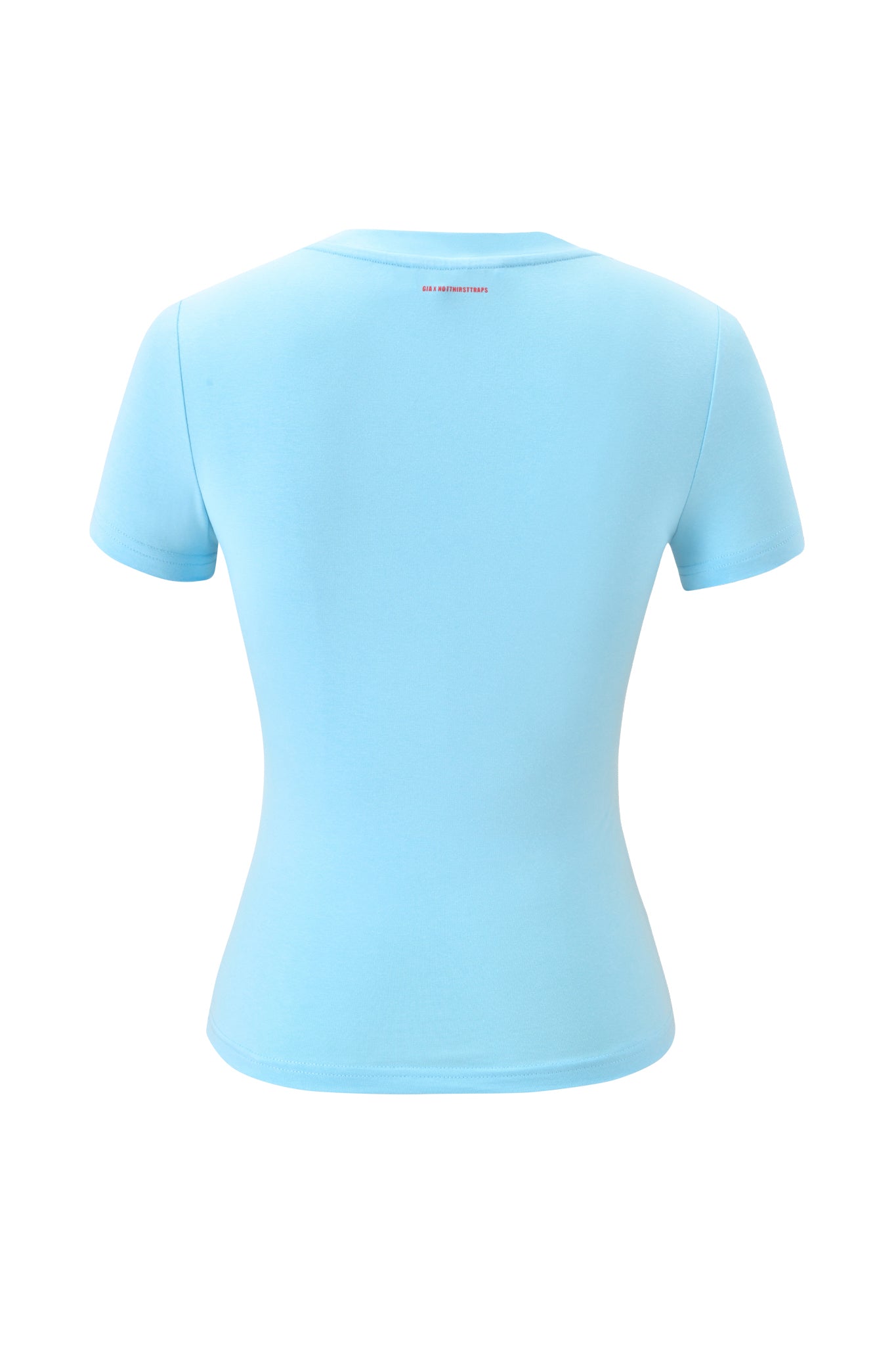 The POLINA TEE - TYPE by I.AM.GIA is a fitted, short-sleeve light blue baby tee shown from the back, featuring a small red logo near the neckline with no other visible designs or patterns.