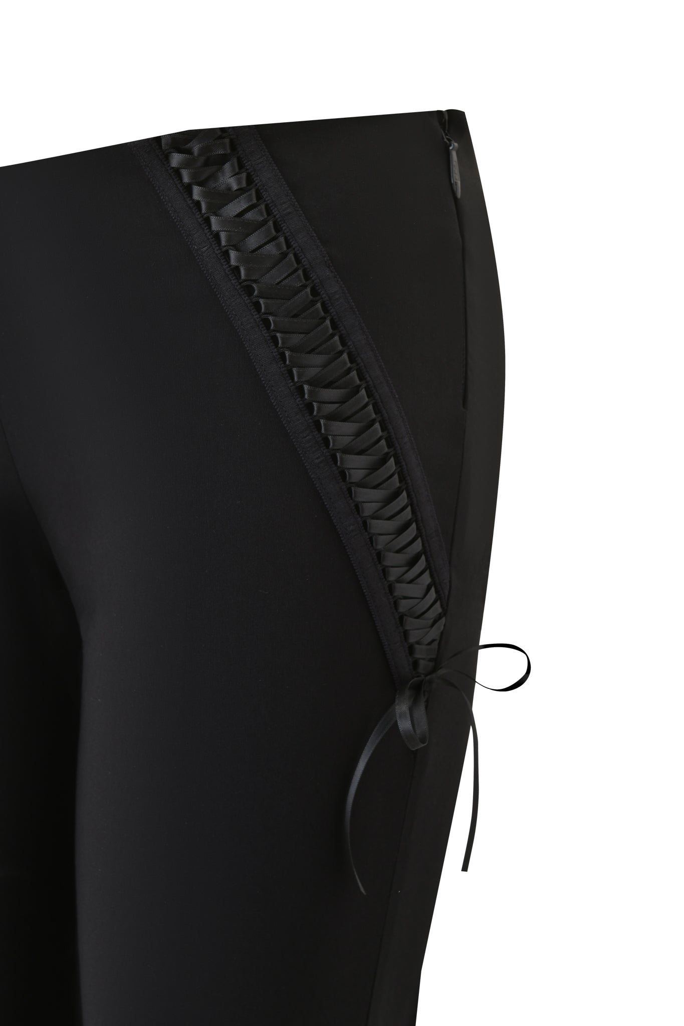 Close-up of the I.AM.GIA SAMIRA PANT in black, featuring a decorative side panel with lace-up detailing and a small bow near the knee, set against a white background.