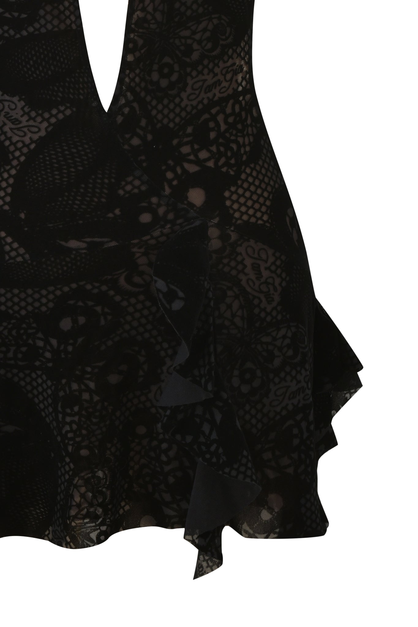 Close-up of the IRISIA MINI DRESS - BURN OUT BLACK by I.AM.GIA, featuring floral-patterned burn-out fabric, sheer panels, a deep V-neckline, ruffled accents, and an asymmetrical hem against a white background.