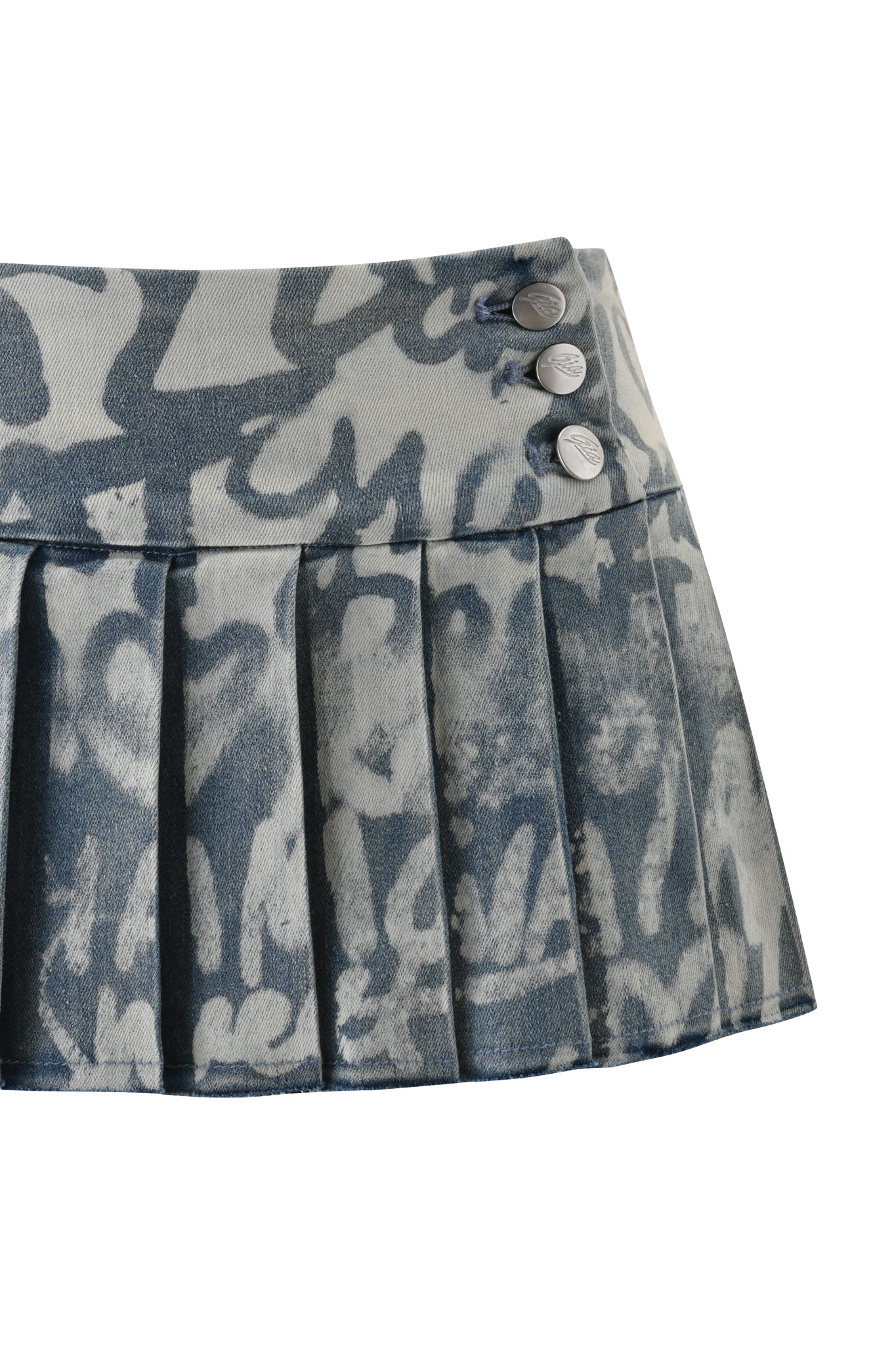 The I.AM.GIA REMINI DISTRESSED DENIM SKORT in Graffiti Light Wash is a pleated mini skort featuring a blue and white abstract pattern and three metallic waistband buttons.