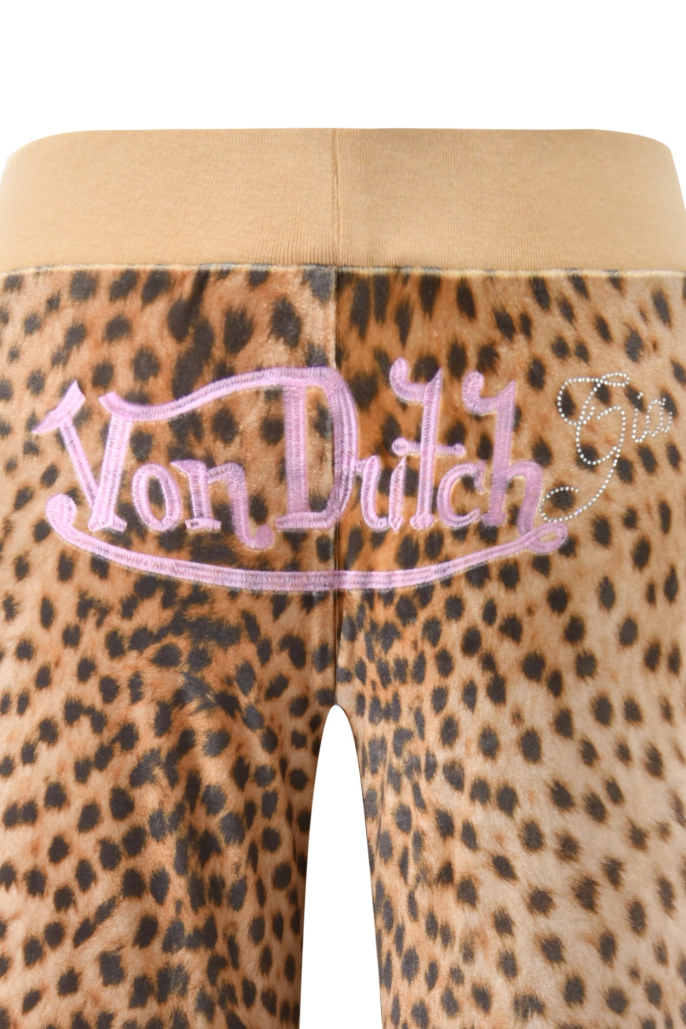 Close-up of the I.AM.GIA X VON DUTCH KAMERON VELOUR TRACKPANT in leopard print, with a beige waistband, pink "Von Dutch" embroidery, and a rhinestone accent on the back.