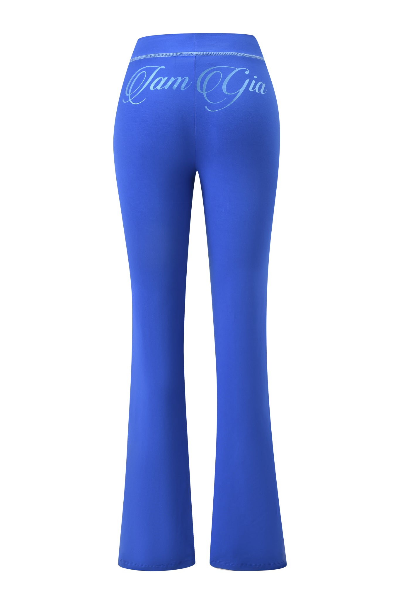 The BLARE FORM POCKET TRACKPANT - COBALT FOIL by I.AM.GIA features a high-waisted, sculpted fit in bright cobalt blue, flared from the back with “I.AM.GIA” in white cursive across the waistband for a stylish trackpant look.