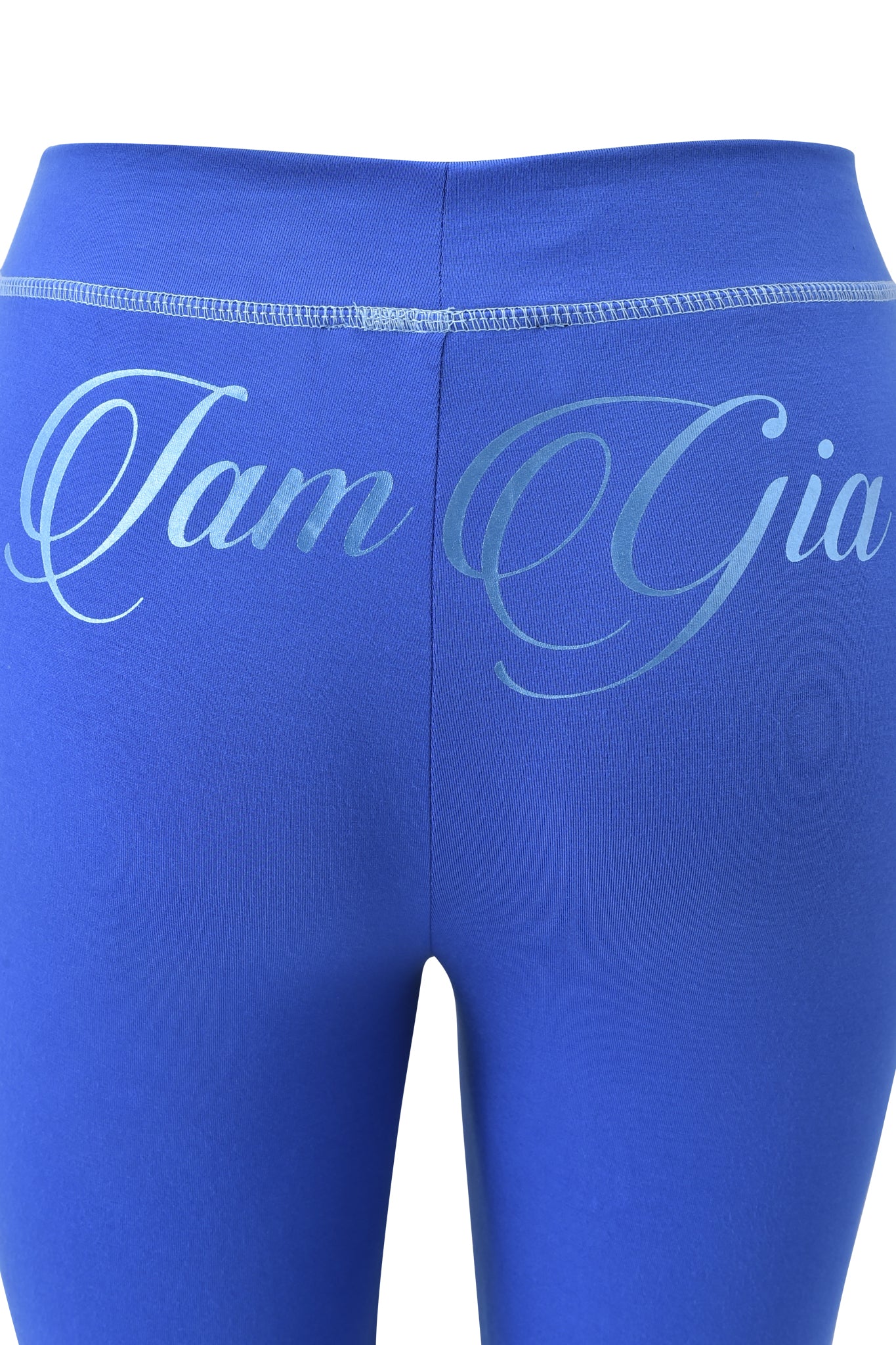 Close-up of the back of BLARE FORM POCKET TRACKPANT - COBALT FOIL by I.AM.GIA featuring large, light blue cursive "I.AM.GIA" lettering across the waistband.
