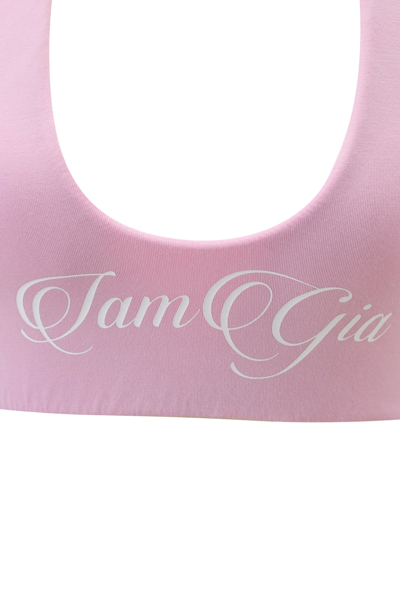 Close-up of the BLARE HALTER CROP TOP in baby pink and white by I.AM.GIA, featuring "I.AM.GIA" in white cursive across the front.