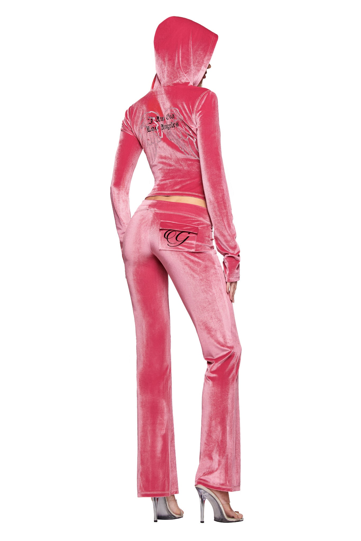 A person wears the I.AM.GIA BLARE VELOUR POCKET TRACKPANT in pink, featuring a mid-rise waist, flared legs, and pocket details with the GIA script logo, paired with high heels and a hooded top with back embroidery, seen from behind.