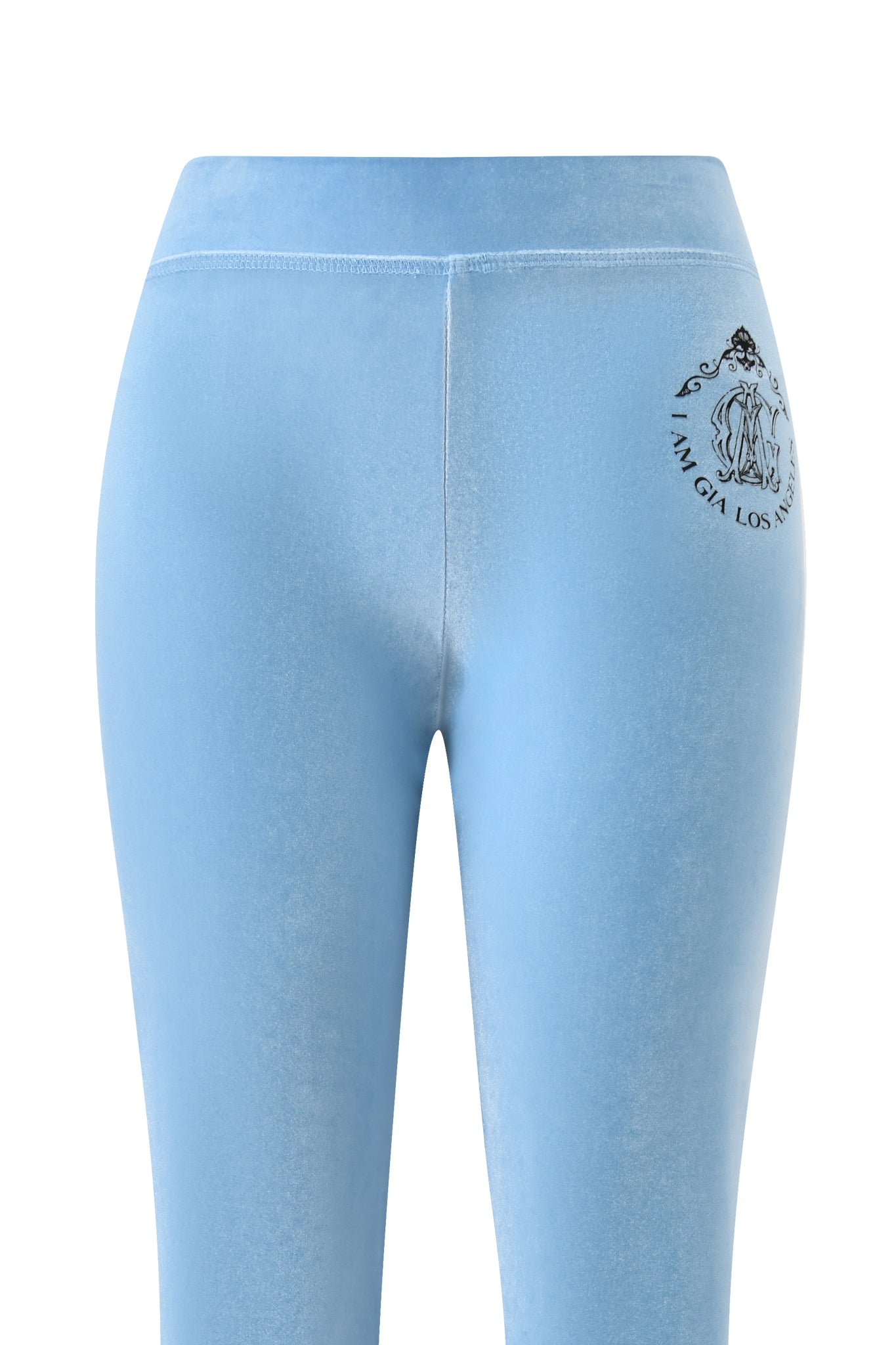 The I.AM.GIA BLARE VELOUR POCKET TRACKPANT in ice blue is a high-waisted velour pant featuring a small black logo and text on the upper left hip.