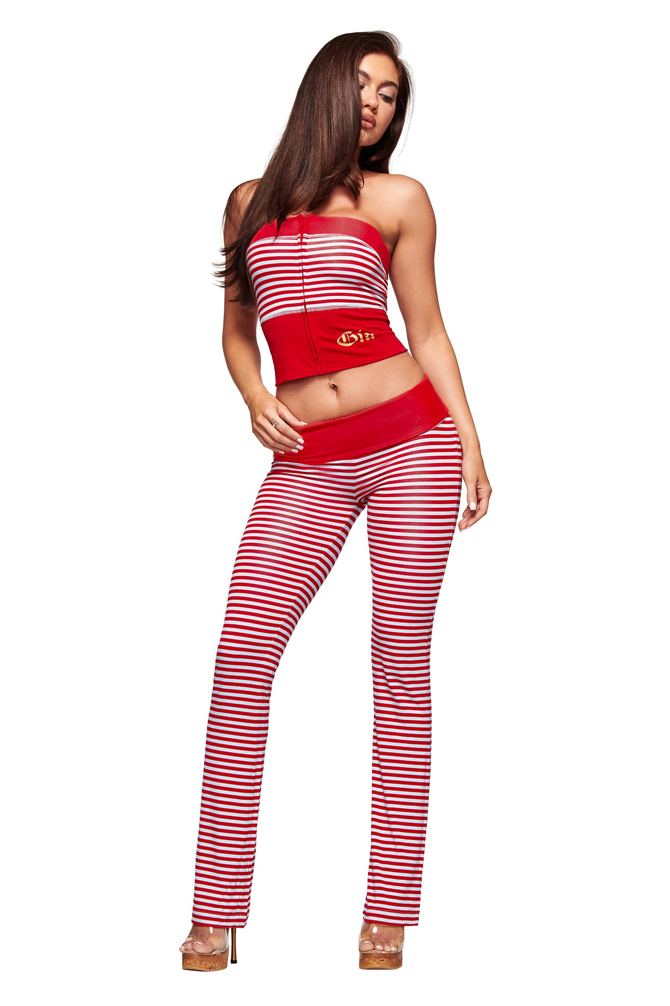 A woman styles red and blue striped I.AM.GIA BLARE ZIP BOOB TUBE with a comfy hoodie, achieving a cozy yet on-trend look.