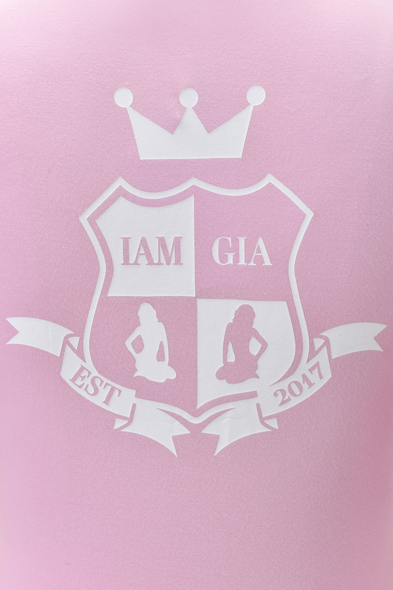 Add I.AM.GIA’s signature style to your look with the white crest logo and “EST 2017” graphic on the BLARE PIPING HOODIE in baby pink and white.