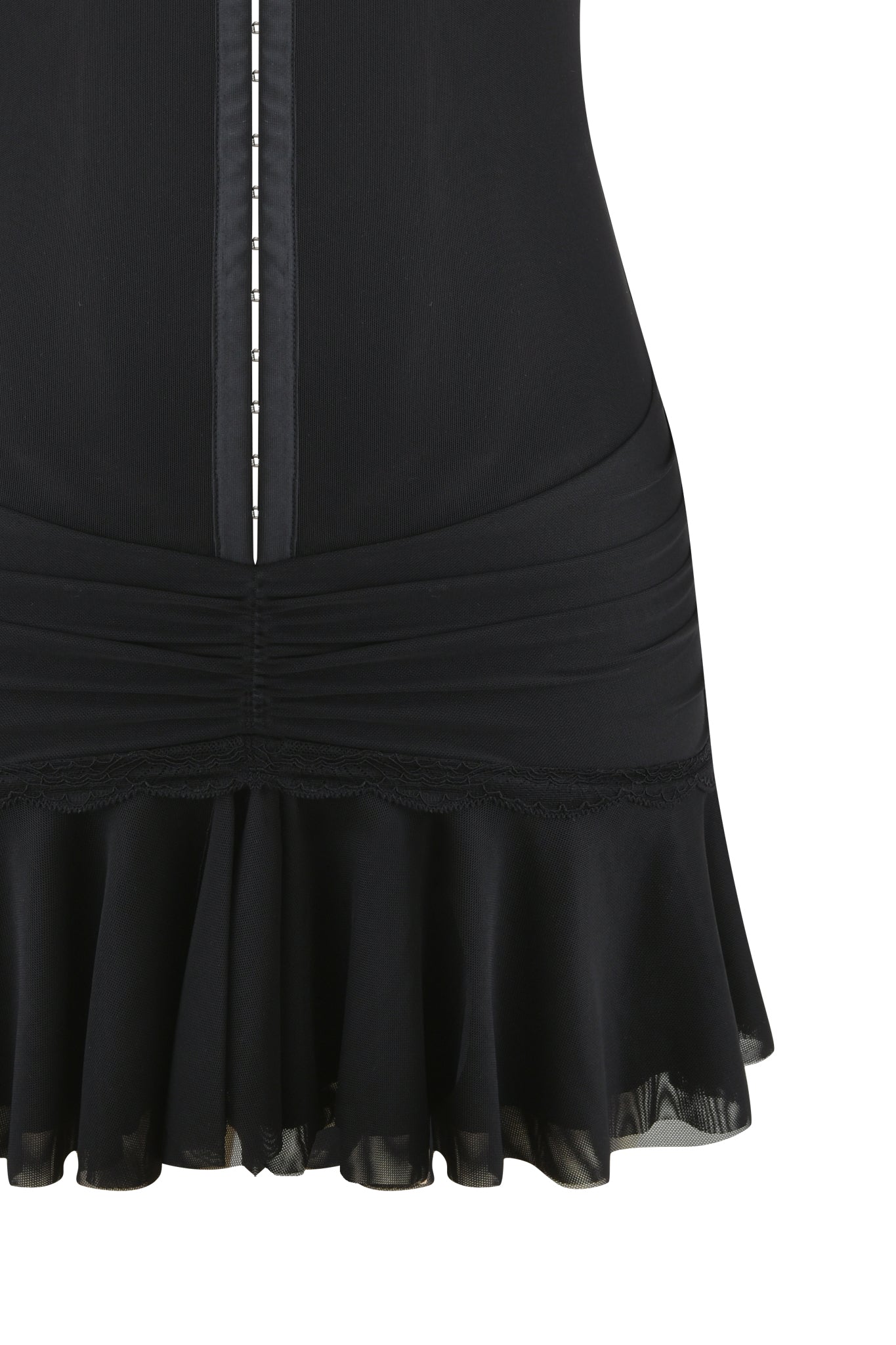 Close-up of the I.AM.GIA ISELA MINI DRESS - BLACK, showcasing a ruched waist, front button detail, and ruffled hem with lace trim. The power mesh mini dress is photographed against a crisp white background.