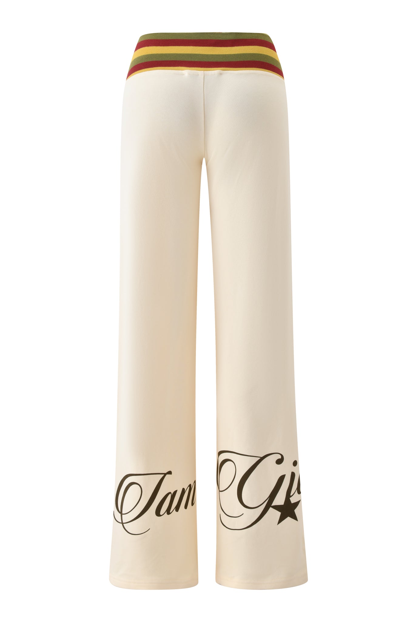 The I.AM.GIA CANDI PANT - CREAM features a green, red, and yellow striped waistband, black cursive text, and a star graphic on the lower legs. Wide leg cream tracksuit pants displayed on a white background.