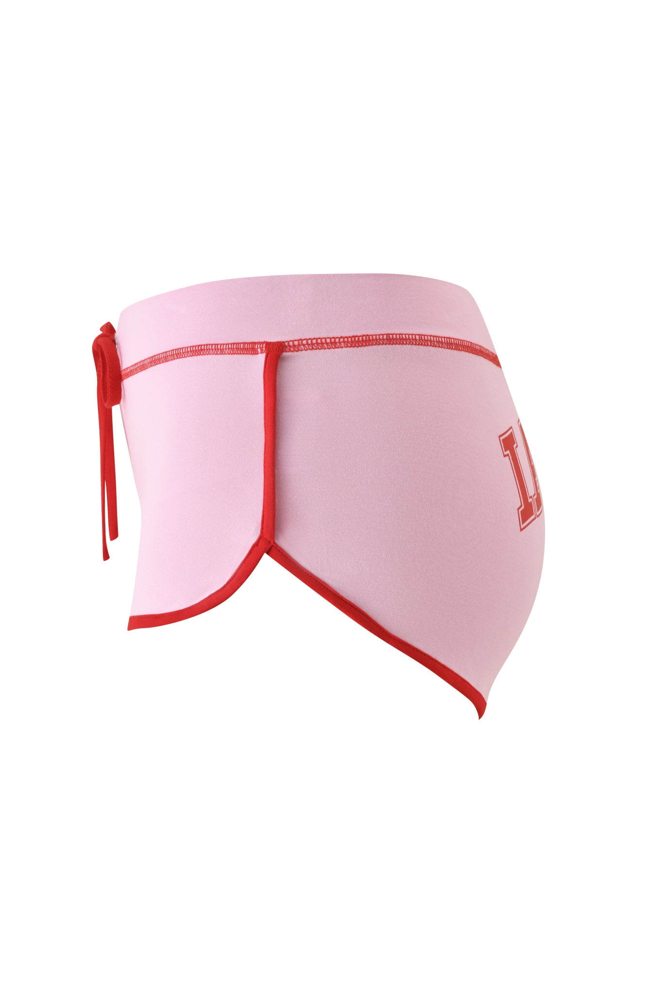 Side view of the I.AM.GIA BLARE DOLPHIN SHORT in baby pink, featuring red trim, a side tie, and an "L" printed on the left—echoing the playful style of classic I.AM.GIA cherry shorts.