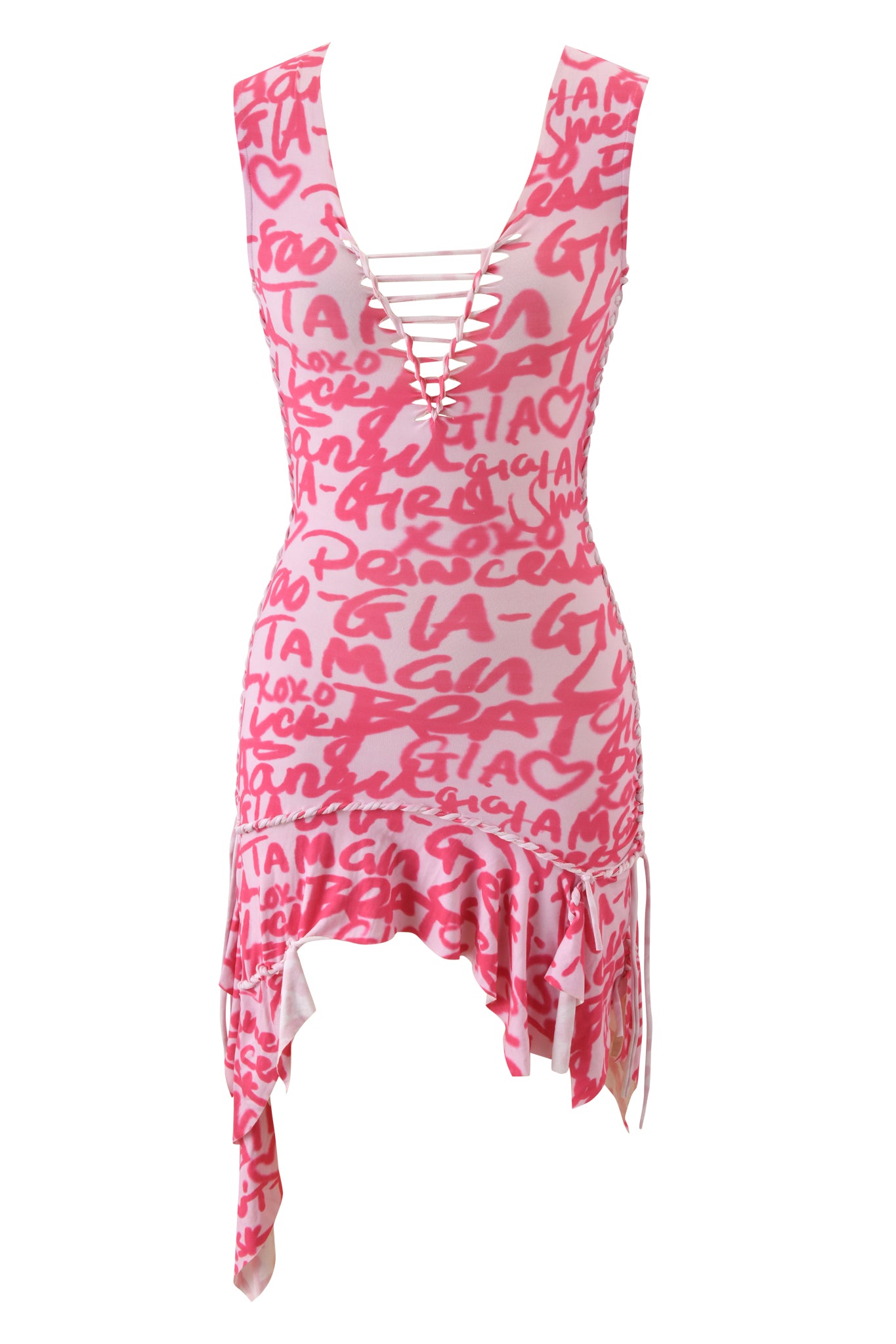 The I.AM.GIA HONEY MACRAME MINI DRESS - PINK WRITING ON THE WALL is a sleeveless bodycon mini dress with hot pink graffiti and hearts on white, a deep V-neck with crisscross laces, and an asymmetrical ruffled hem.