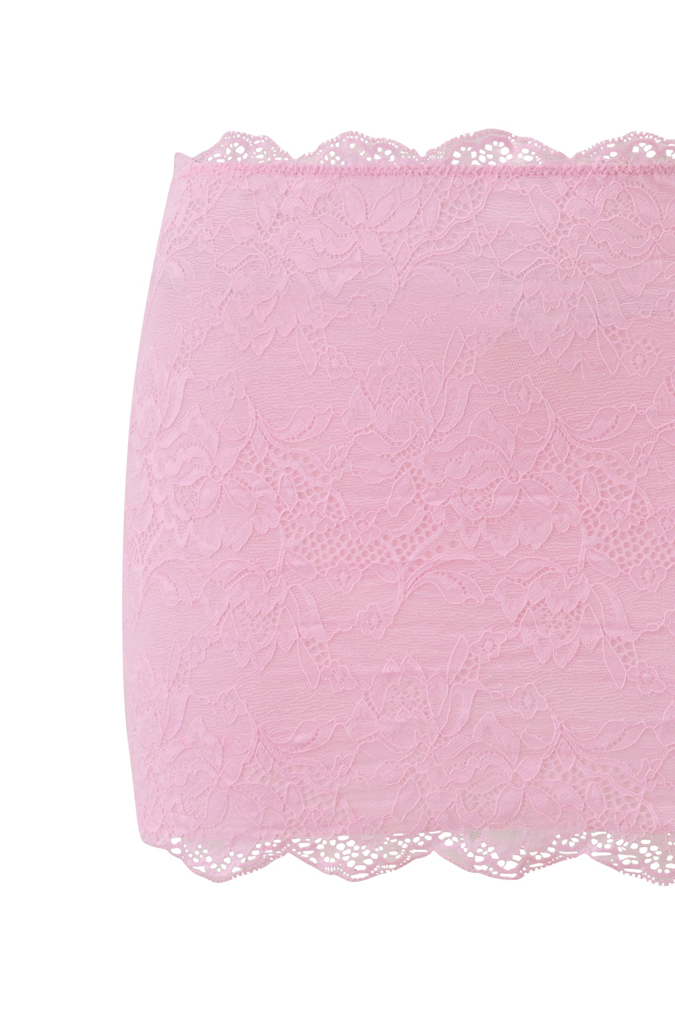 A close-up of the SALLI LACE MINI SKIRT - BABY PINK by I.AM.GIA, featuring light pink floral lace with scalloped edges, styled effortlessly chic with a matching bandeau.