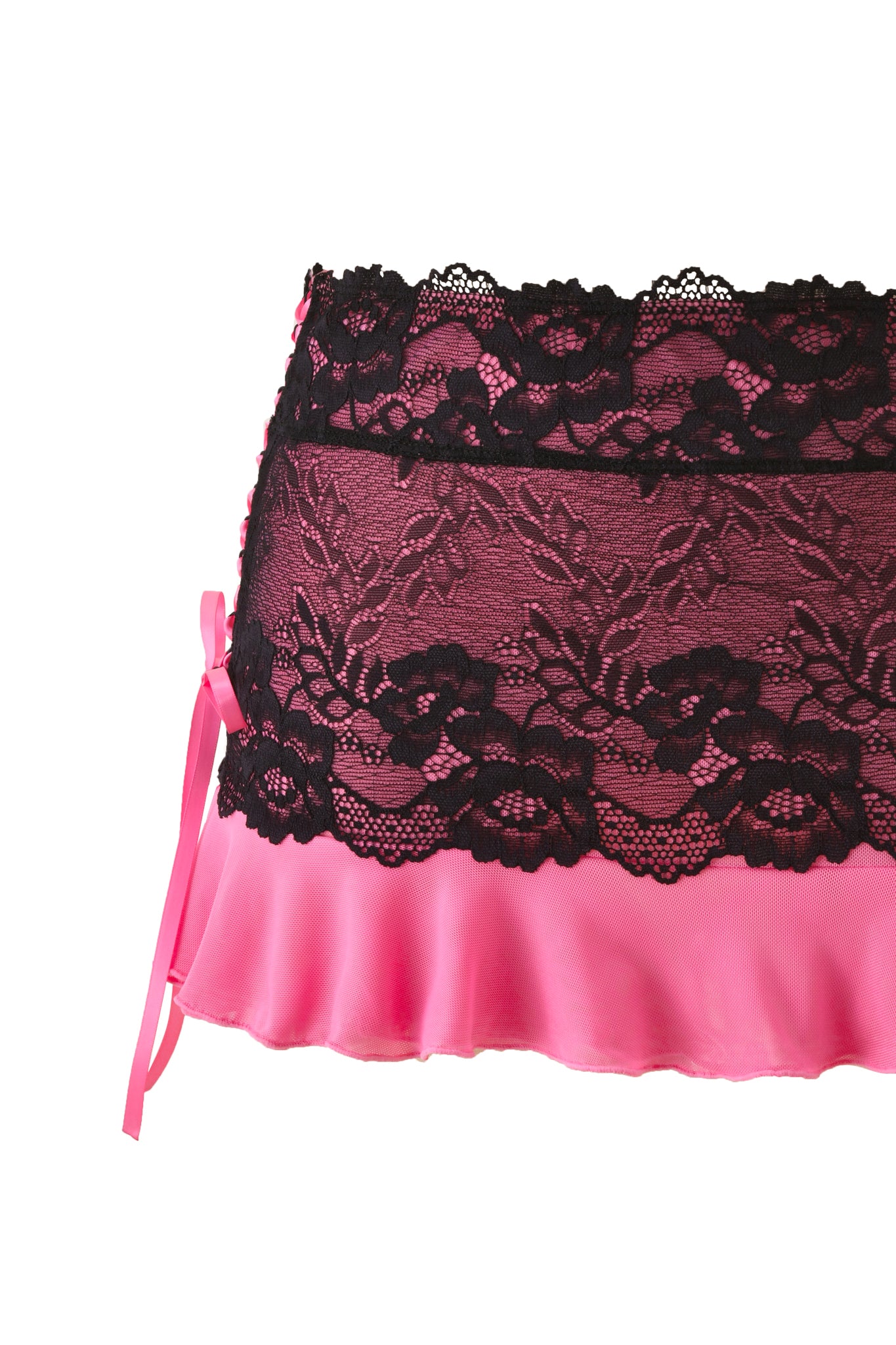 The TIFFANY SKIRT - PINK by I.AM.GIA is a hot pink mesh skirt with a black lace floral overlay and a satin ribbon bow on the left side, shown against a white background.