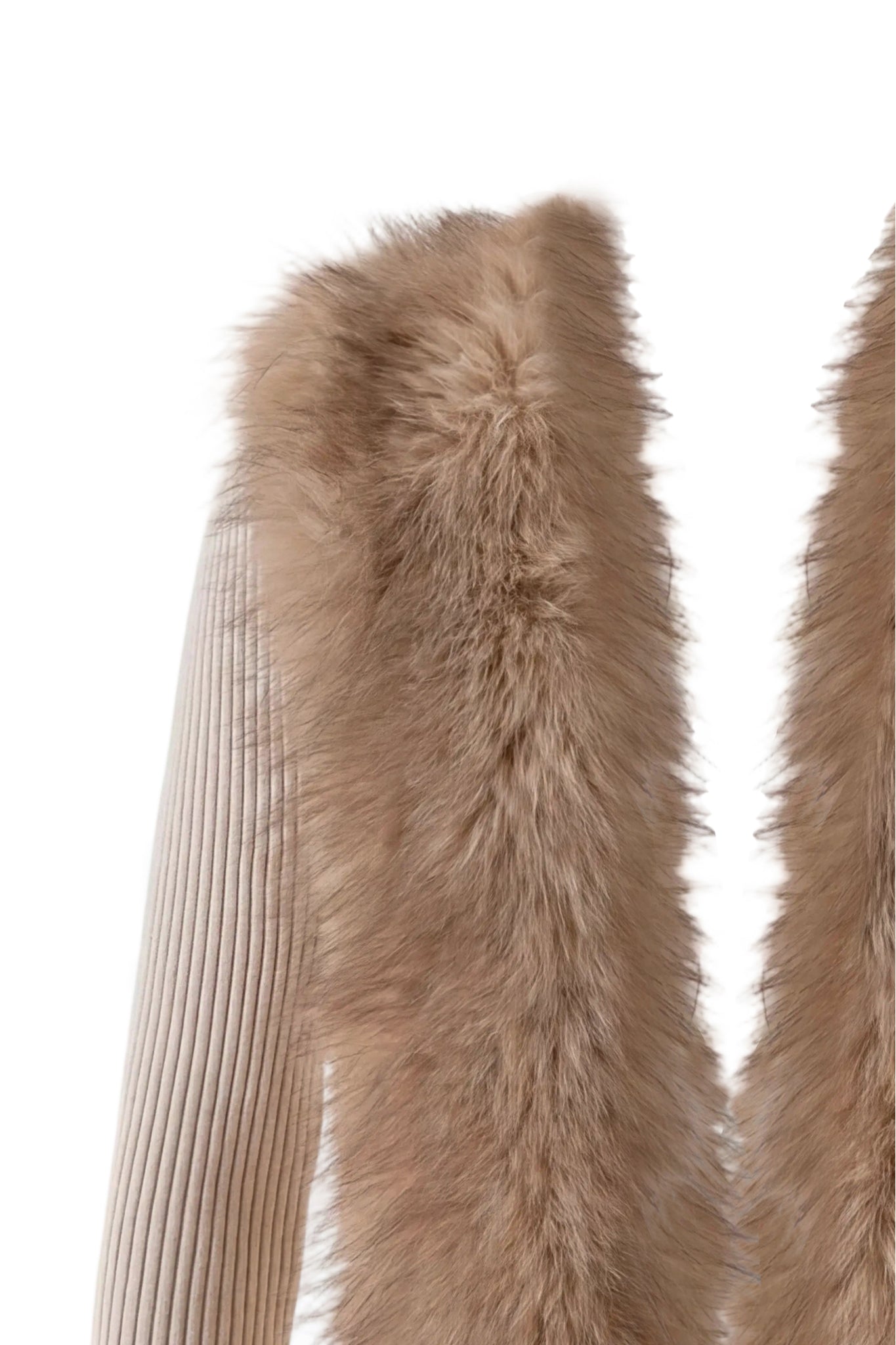 Close-up of the KYTIA FAUX FUR CARDIGAN - BEIGE by I.AM.GIA, featuring a beige rib knit sleeve beside a panel of soft, light brown faux fur collar against a white background—ideal for cozy winter layering.