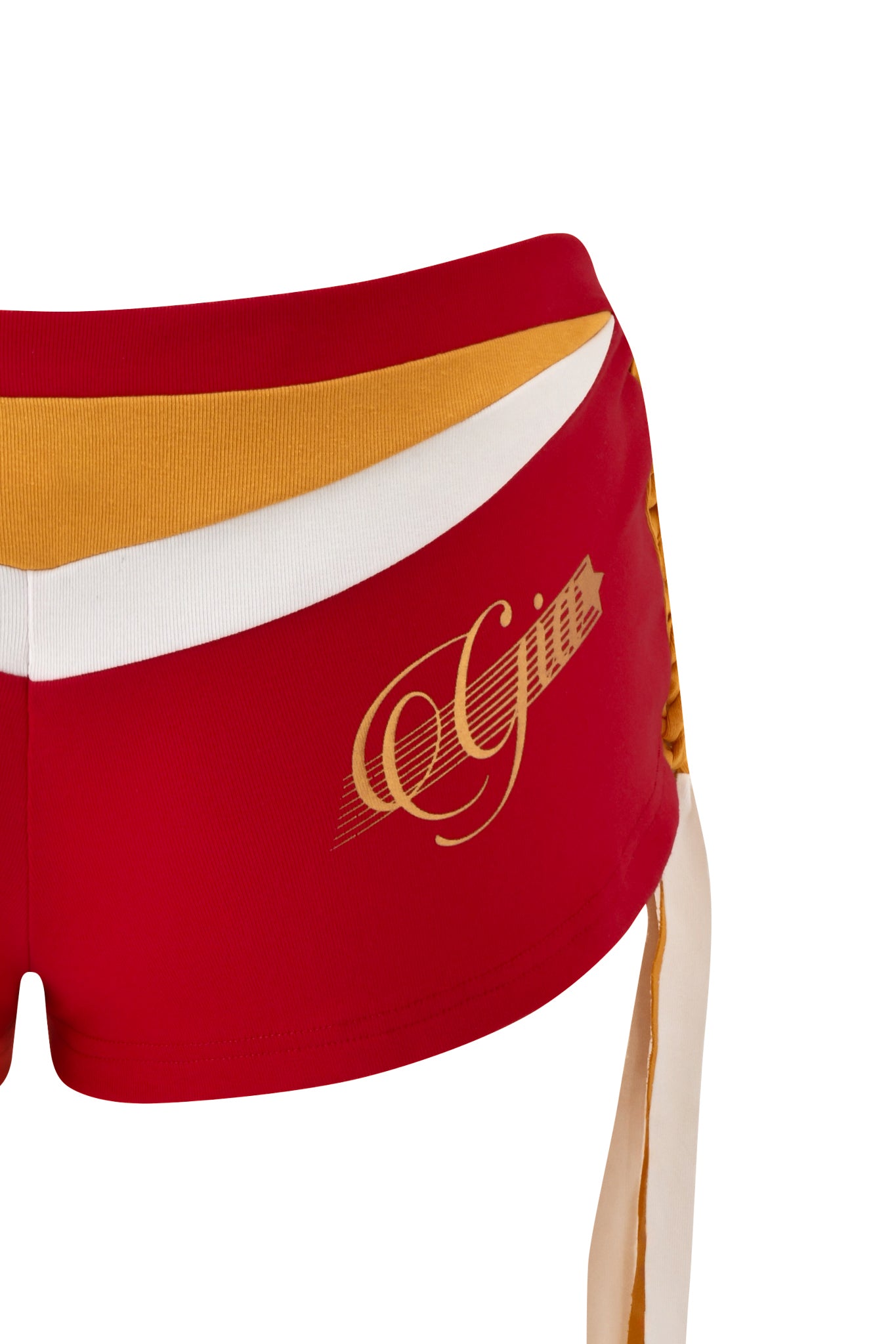 The NOVIA MICRO SPORT SHORT in red by I.AM.GIA features a yellow and white waistband and gold "Gija" script on the left. The image shows only the lower torso and upper thigh against a white background, inspired by classic I.AM.GIA soccer shorts.