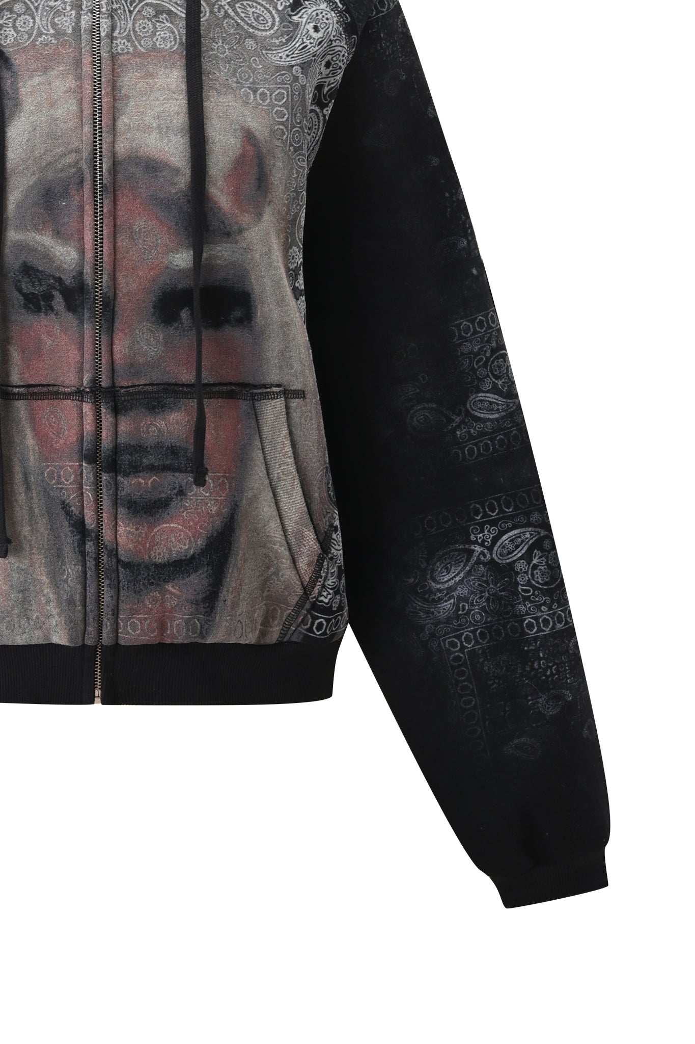 The I.AM.GIA T-REX ZIP THRU HOODIE - BLACK BANDANA features a striking black and gray design with a bold abstract face graphic and paisley patterns, shown from the chest down with one sleeve visible against a white background, making it the ultimate statement piece for street style.