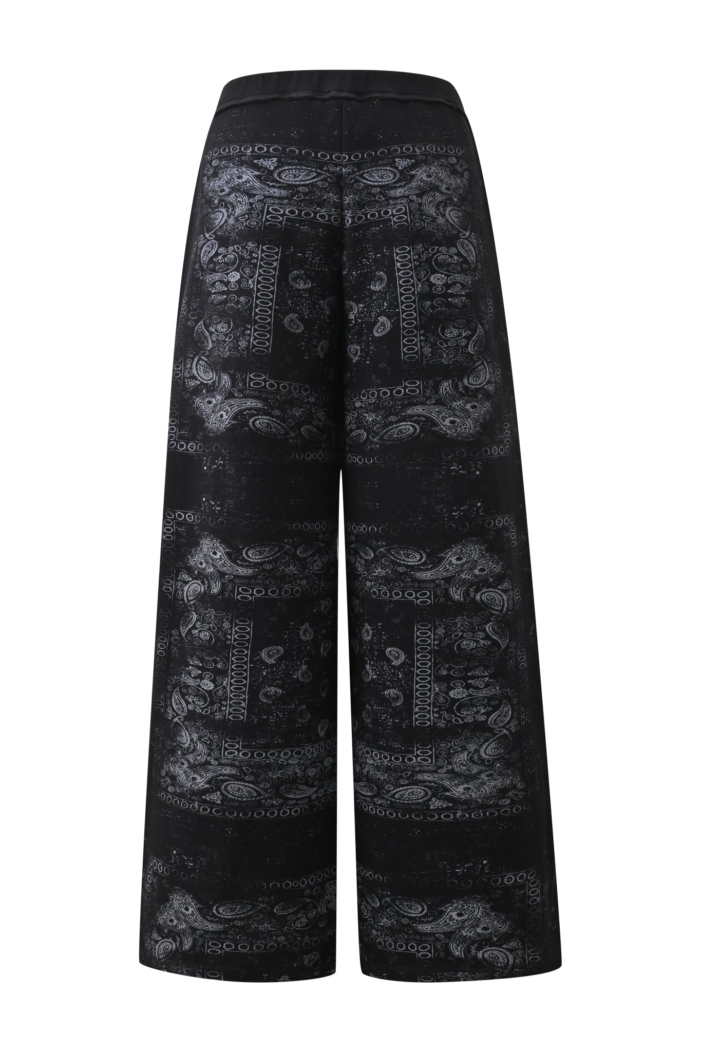 The I.AM.GIA T-REX TRACKPANT in Black Bandana features a wide-leg silhouette and high waist, adorned with an intricate white paisley and geometric bandana-style pattern. Shown from the back against a white background, these trackpants are perfect for elevating your street style.