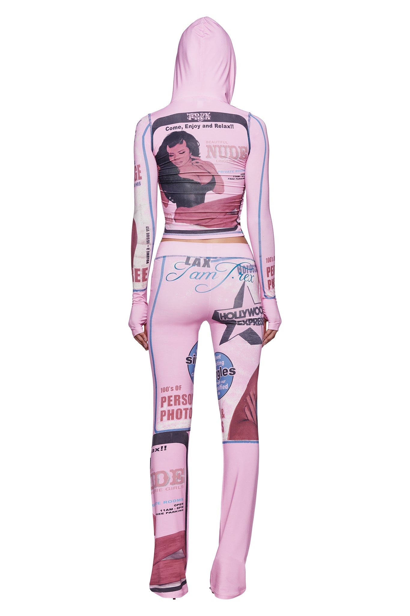 A person is shown from the back wearing a pink hooded jumpsuit featuring a wide elastic waistband and vintage-inspired magazine graphics, including a bold T-REX print in pink—style it with the I.AM.GIA T-REX BLARE TRACKPANT - PINK for an eye-catching ensemble.