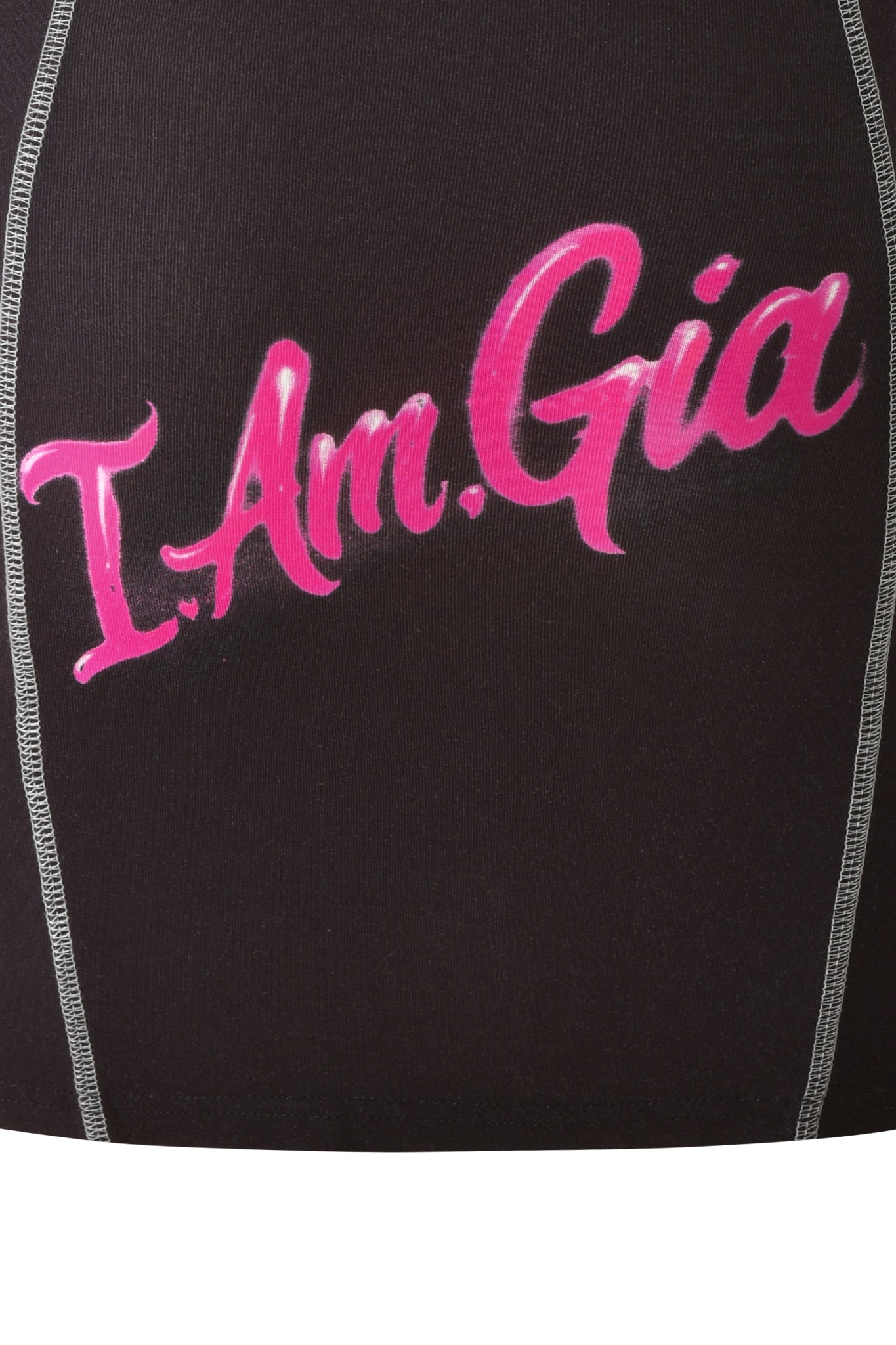 Close-up of black fabric with white stitching and “I.Am.Gia” printed in bright pink cursive text, showcasing the signature print from the I.AM.GIA T-REX BLARE BOOB TUBE MINI DRESS in black.