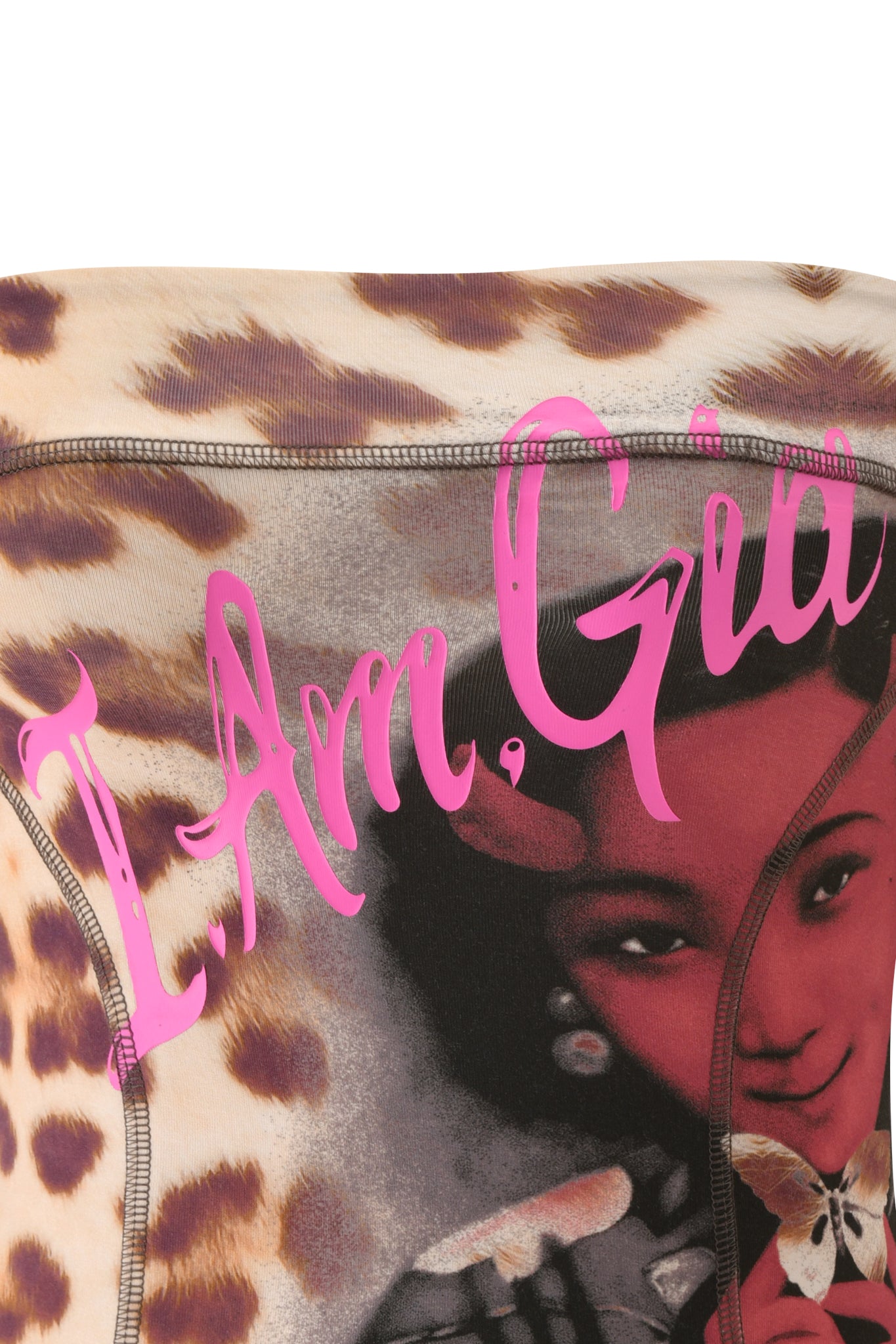 Close-up of the T-REX BLARE BOOB TUBE - WILD CARD by I.AM.GIA, featuring leopard print fabric with part of a woman's illustrated face and hand holding a butterfly. Bright pink script text at the top reads "I Am Gia." This festival top exudes bold style, making it perfect for those after an edgy look.