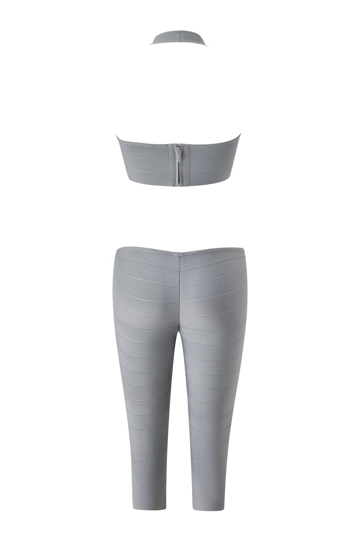 Back view of the I.AM.GIA EVA BANDAGE CAPRI JUMPSUIT in grey, featuring a halter crop top design and high-waisted, fitted capri pants with horizontal panel detailing for a sleek, modern look reminiscent of a grey bandage catsuit.