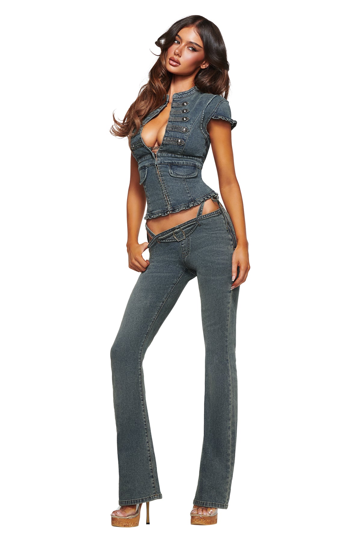 A woman models the JET DENIM TOP in Faded Indigo by I.AM.GIA—a fitted denim piece with cutout details—paired with flared pants and high-heeled shoes, channeling iconic Y2K style while standing against a white background.