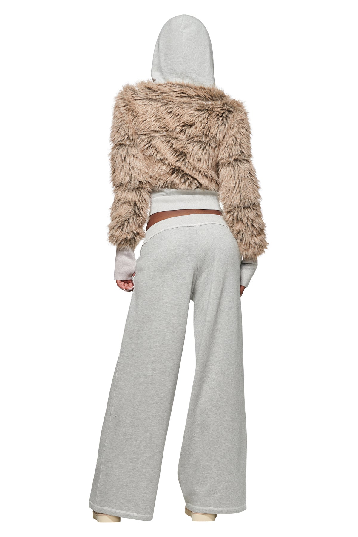 A person is seen from behind, standing against a white background, wearing the I.AM.GIA KOKO FUR FLEECE HOODIE in heather grey with beige faux fur paneling, styled with wide-leg gray sweatpants.