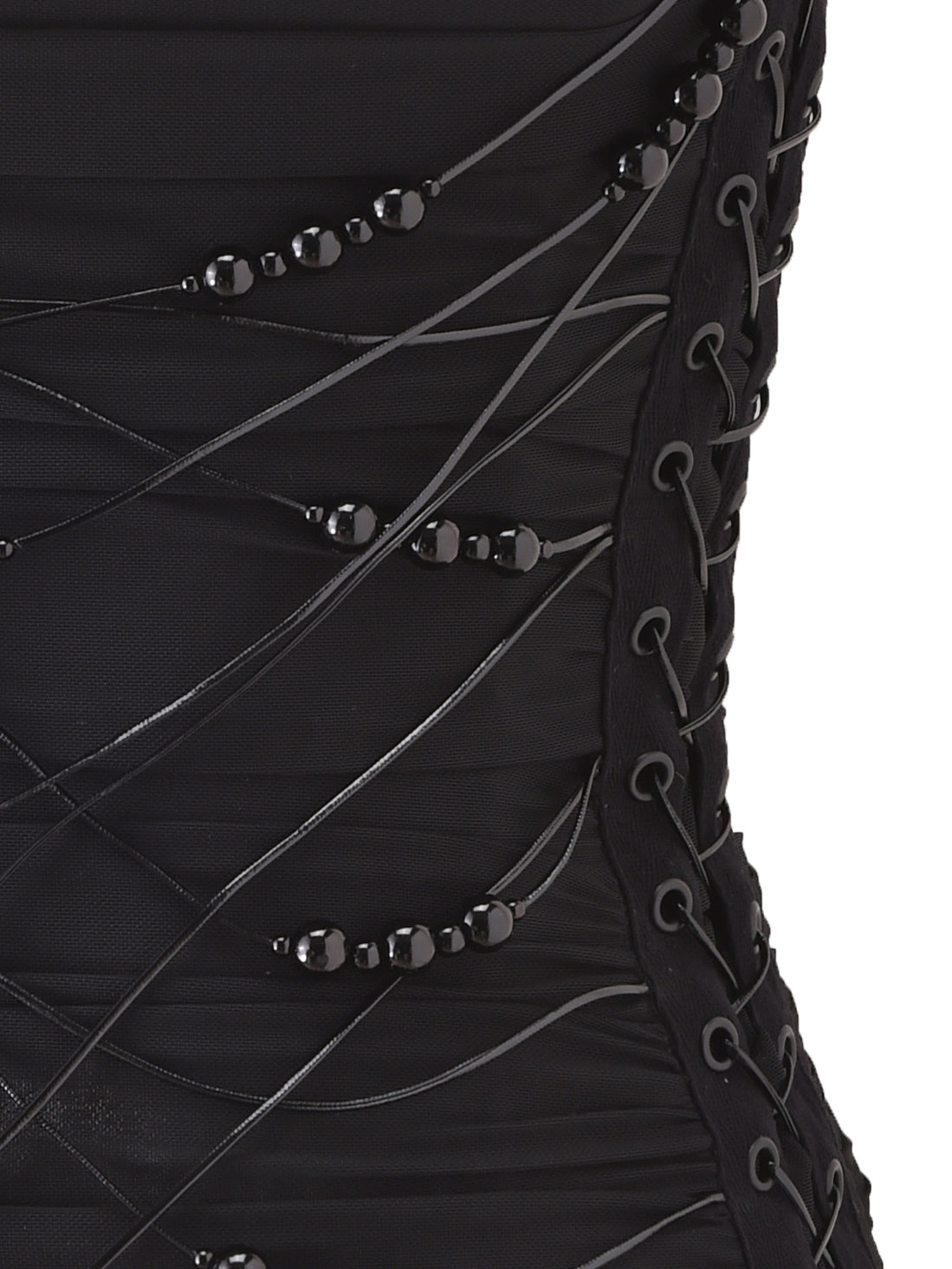 Close-up of the I.AM.GIA DIXI CORSET in black, featuring a strapless mesh design with crisscrossed laces, vertical rows of grommets along the edge, and accents of black beads. The textured fabric exudes elegance, while delicate lace trim details provide a sophisticated finish.