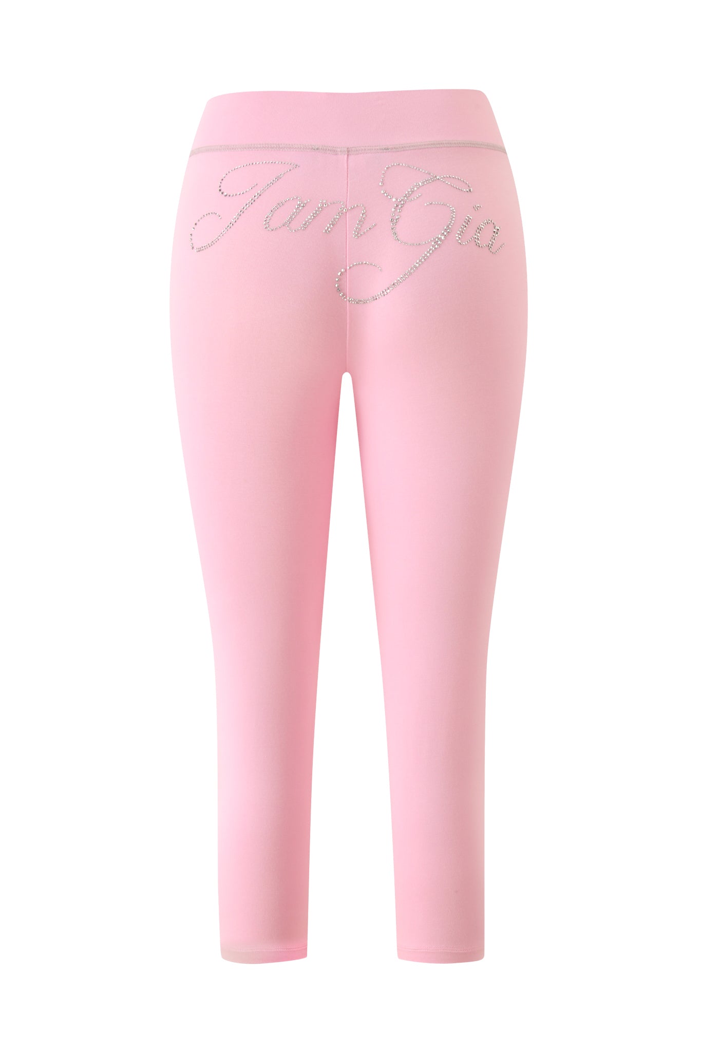 The BLARE LOW RISE DIAMONTE CAPRI in Baby Pink by I.AM.GIA are low-rise capri leggings seen from the back, featuring “I.AM.GIA” spelled out in rhinestones across the waistband. Their soft baby pink hue adds a playful touch to any outfit.