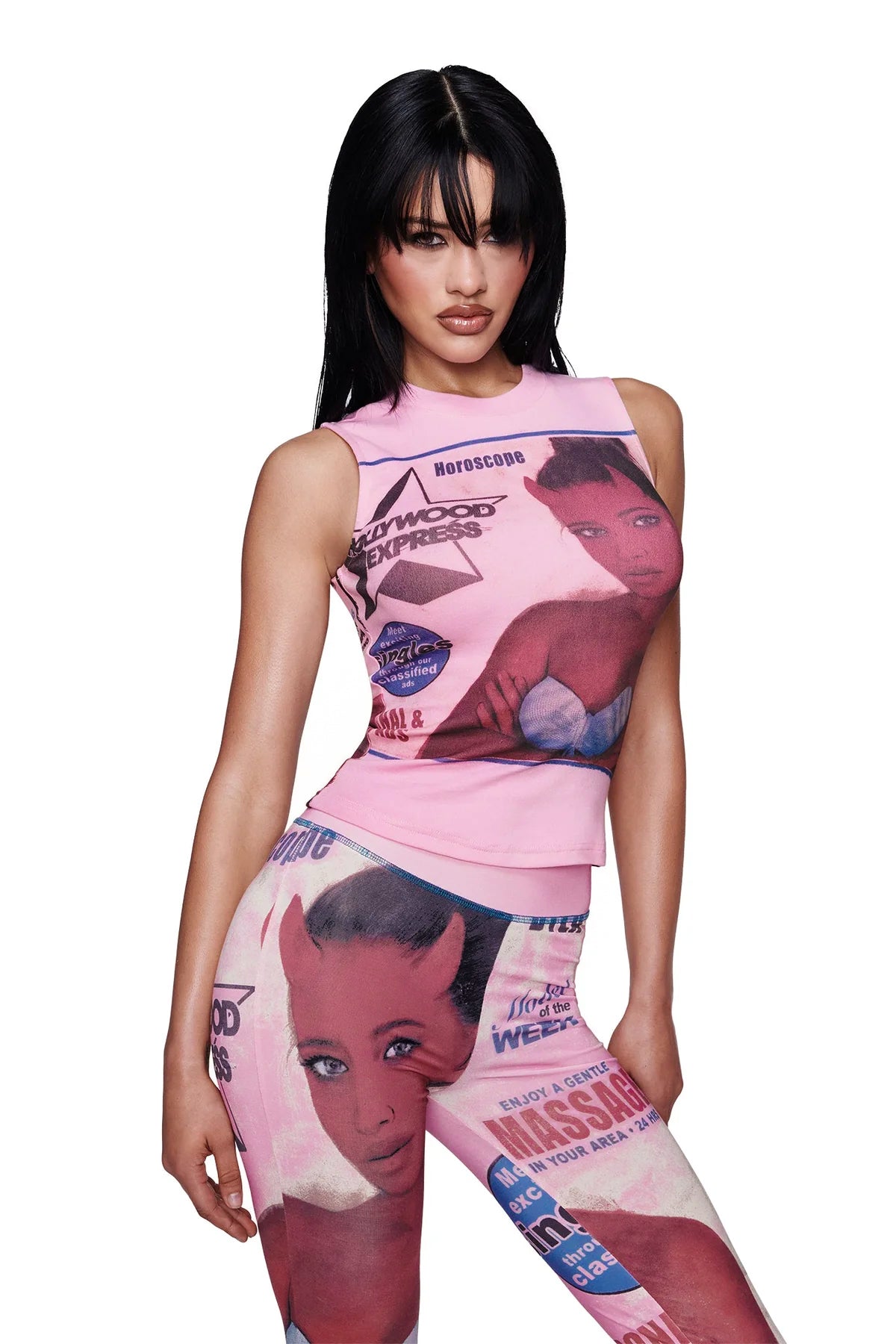 A woman with long black hair poses against a plain white background wearing the I.AM.GIA T-REX COURTNEY TANK in pink, a fitted baby pink muscle tank adorned with bold graphic cartoon prints and text, paired with matching pants.