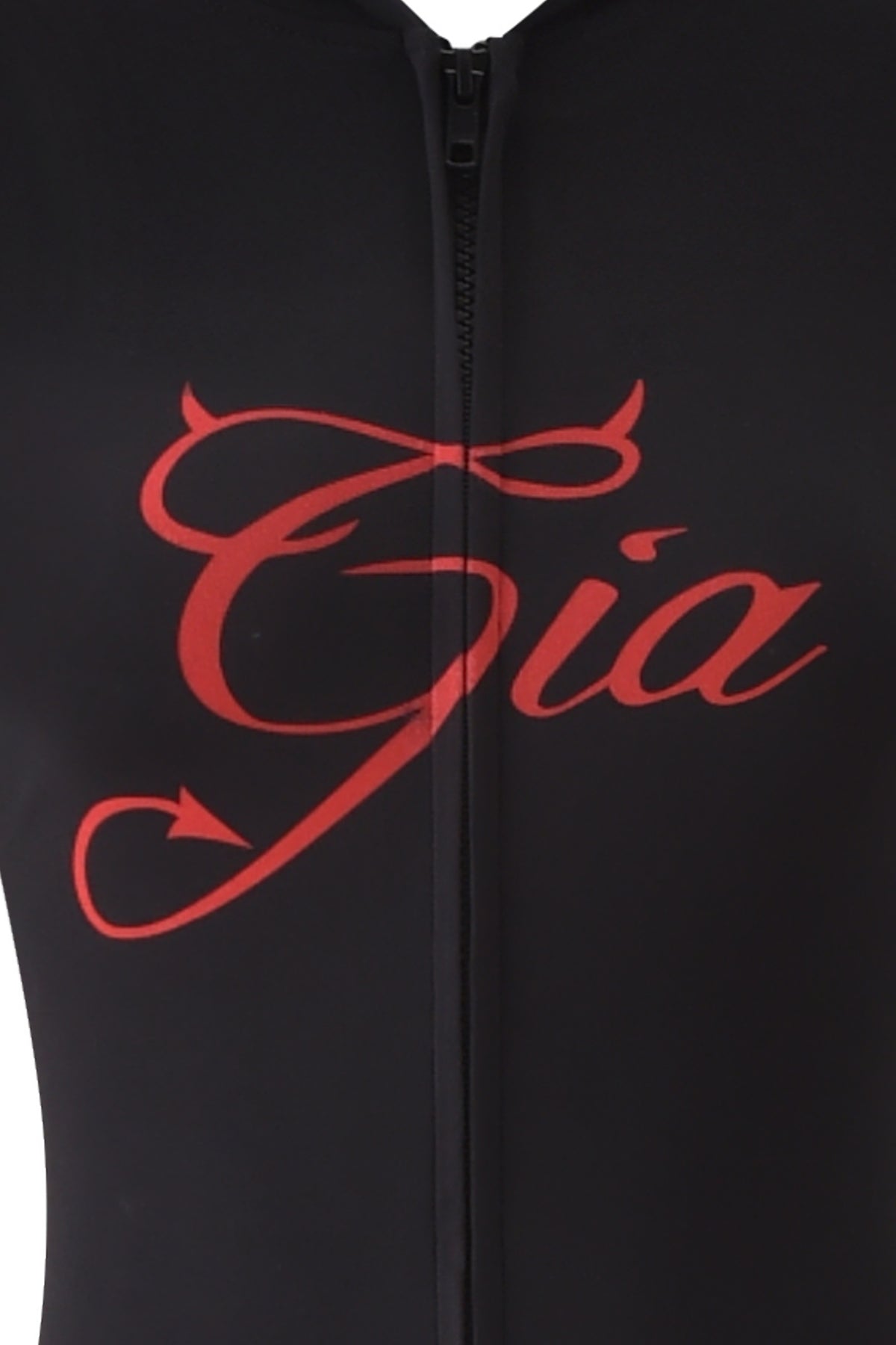 Close-up of the BLARE HORN JUMPSUIT - BLACK by I.AM.GIA, featuring a zipper, “Gia” in red script with devil horn and tail details, and the brand’s iconic devil horn hood.