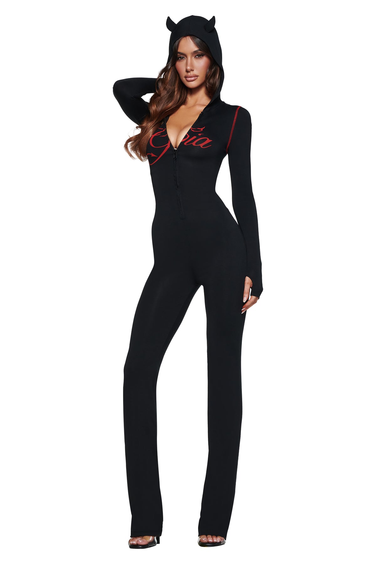 A woman stands confidently in the BLARE HORN JUMPSUIT - BLACK by I.AM.GIA, featuring a devil horn hood, deep V neckline, and “Gia” in red on the chest.