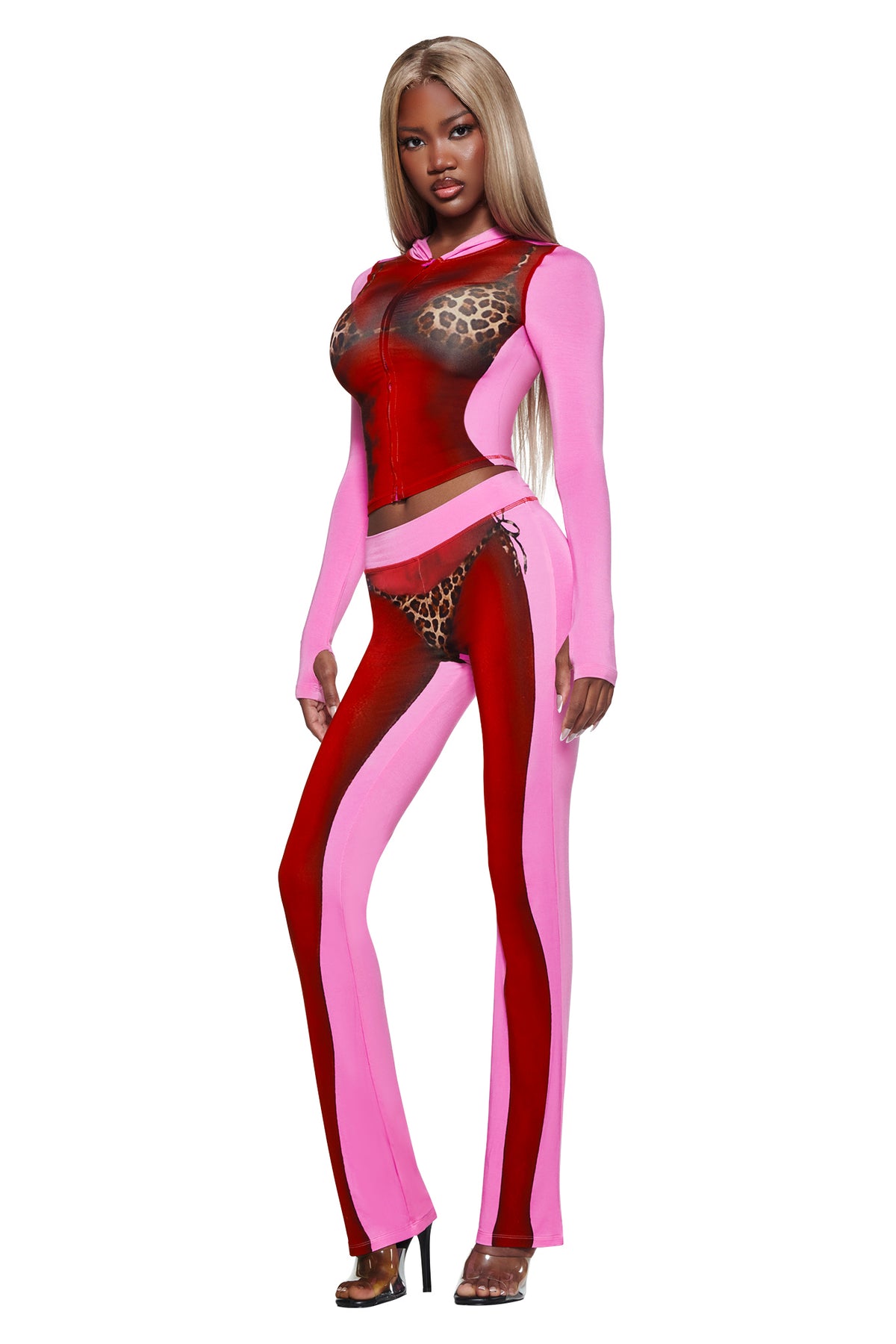 Woman in the T-REX SPRAY BODY BLARE HOODIE - PINK by I.AM.GIA, featuring animal print accents, sheer panels, and a bold airbrushed bikini body print, standing against a white background.