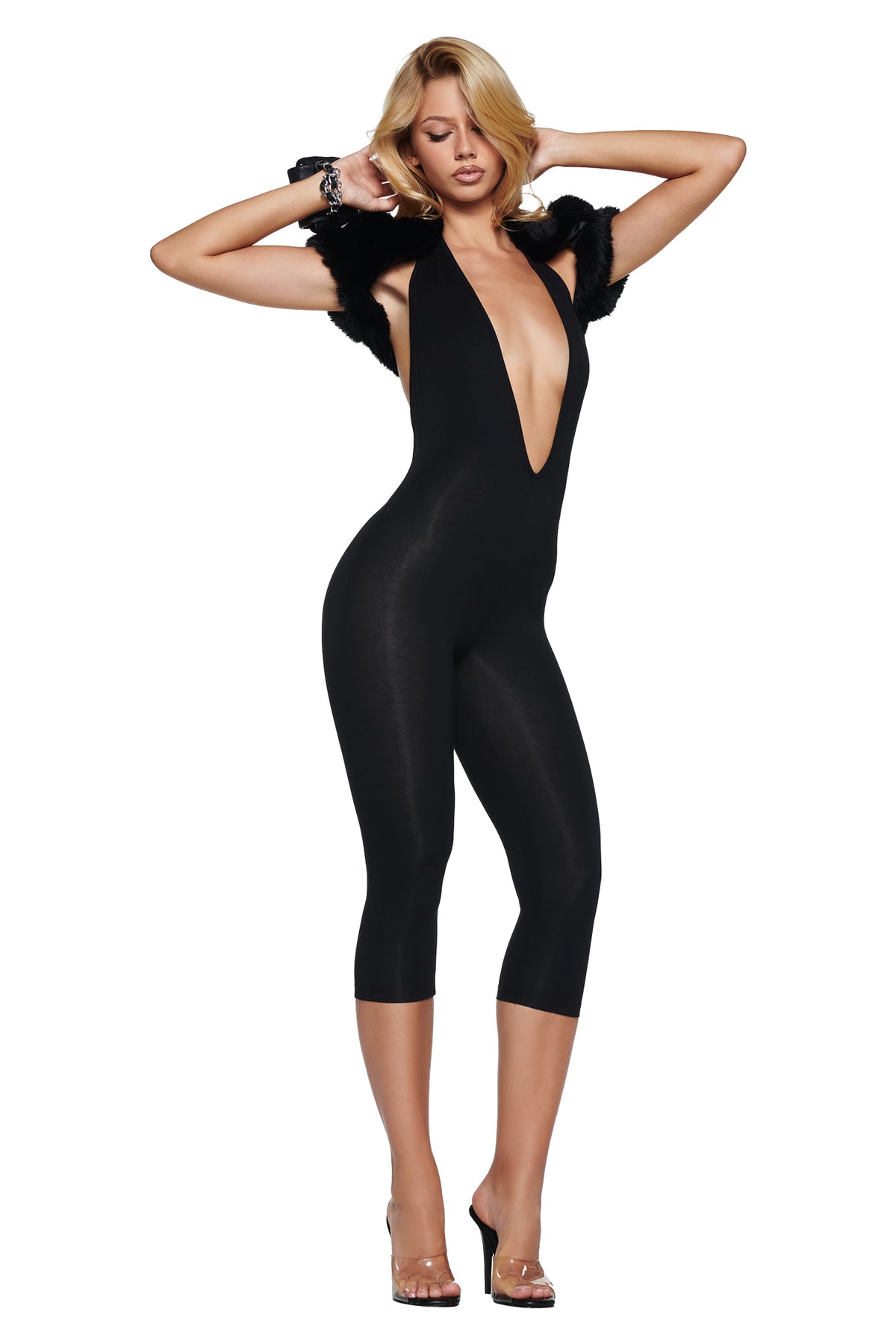 A person wears a black, sleeveless BLARE HALTER CAPRI JUMPSUIT with a deep neckline, an open back, and black faux fur trim at the shoulders.
