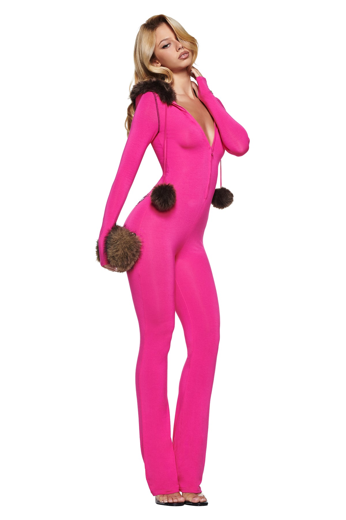 A woman wears a bright pink I.AM.GIA YVL BLARE FUR LINED JUMPSUIT with a flare leg pant, faux fur-trimmed hood, and pom-pom drawstrings.