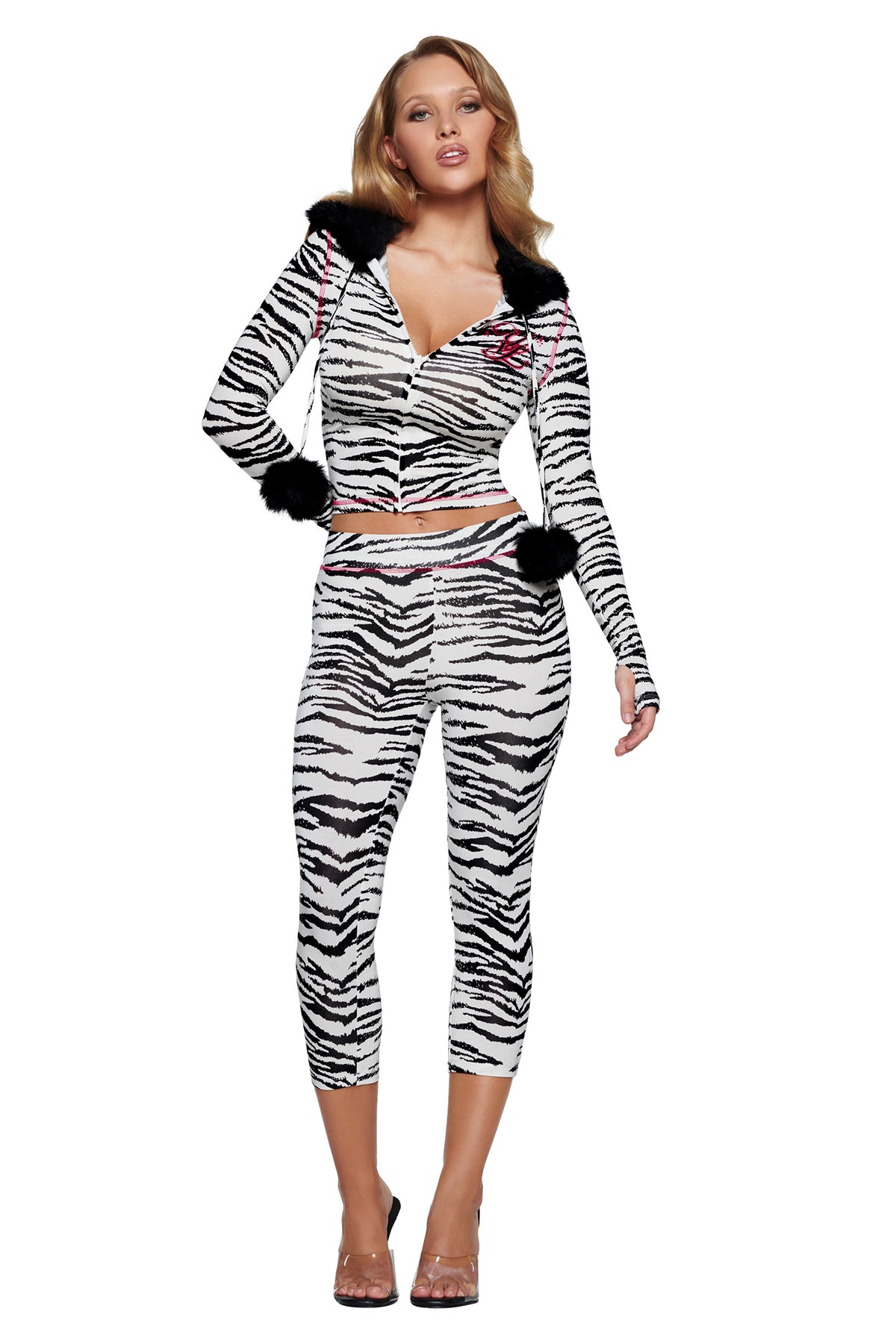 A woman wears an I.AM.GIA YVL BLARE FUR LINED HOODIE - ZEBRA and matching cropped leggings, both featuring black faux-fur trim on the hood and cuffs.