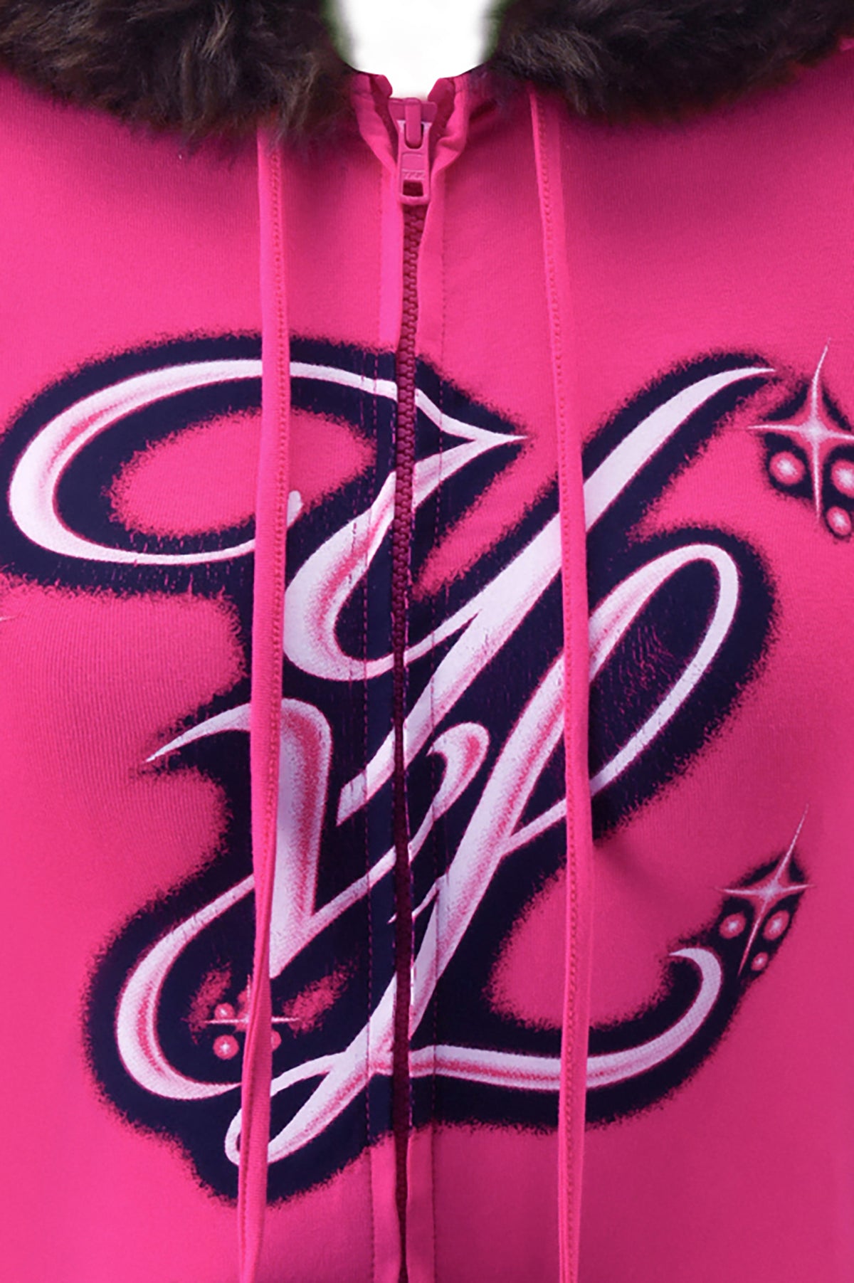 Bright pink I.AM.GIA YVL BLARE FUR LINED CAP SLEEVE HOODIE featuring a dark faux fur-trimmed hood and a large stylized “YVL” graphic in white and navy.