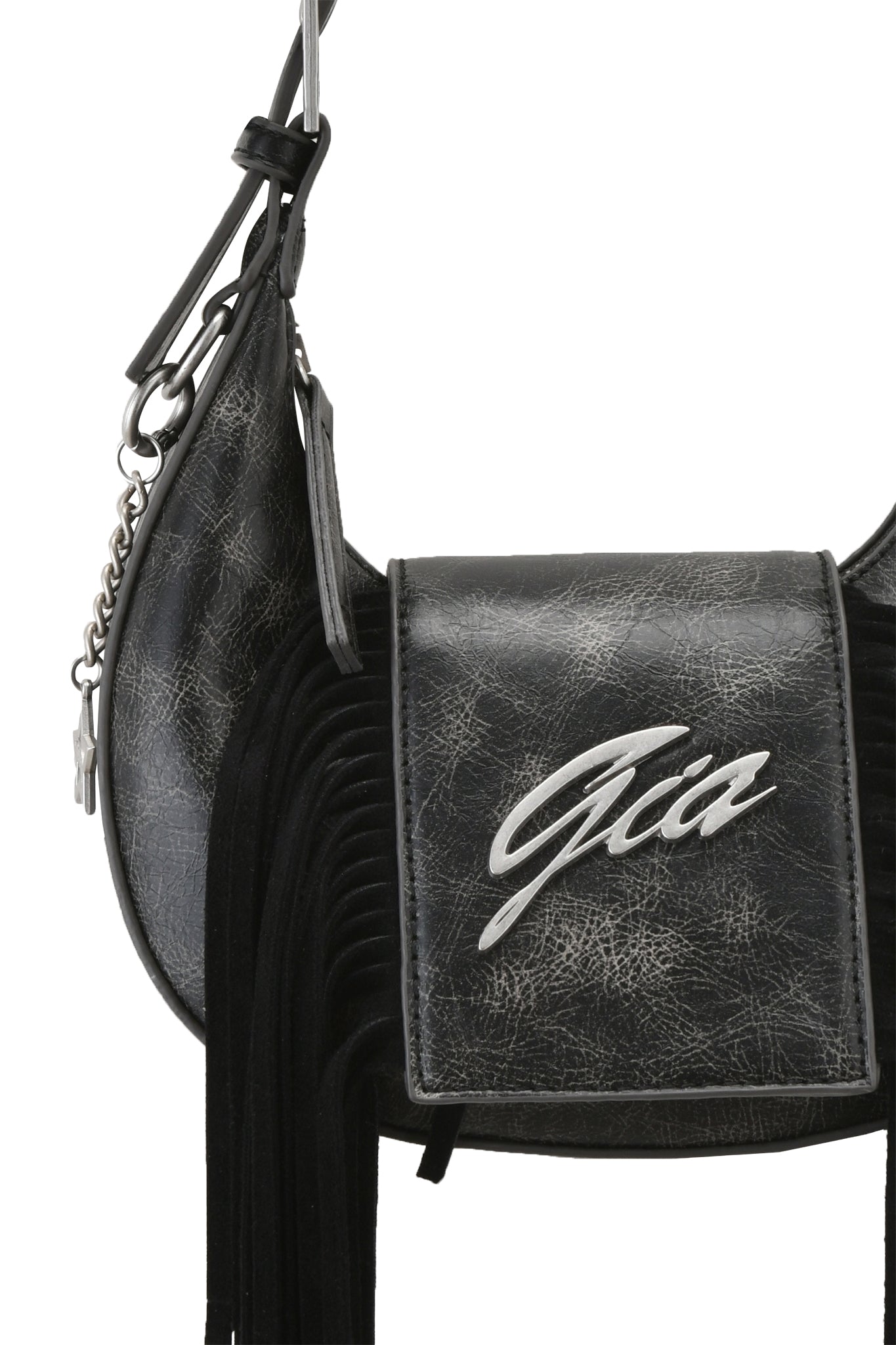 A close-up of the I.AM.GIA TIA BAG - BLACK FRINGE, a black faux leather shoulder purse with black fringe, an adjustable strap featuring a silver chain accent, and a silver "GIA" logo on the flap.