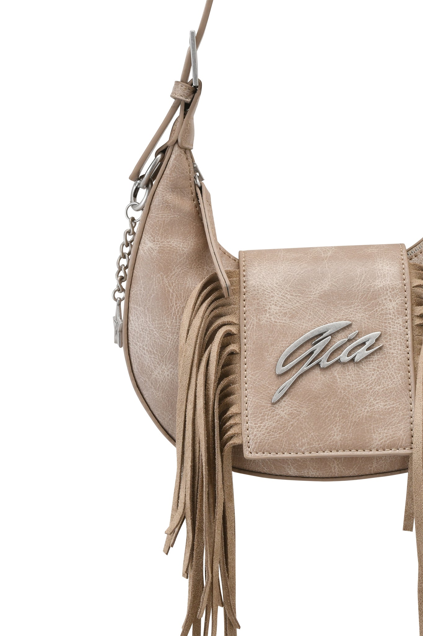 The TIA BAG - TAN FRINGE by I.AM.GIA is a tan faux leather shoulder purse with suede fringe, a front flap with a metallic "Gia" logo, and a strap featuring a silver chain.