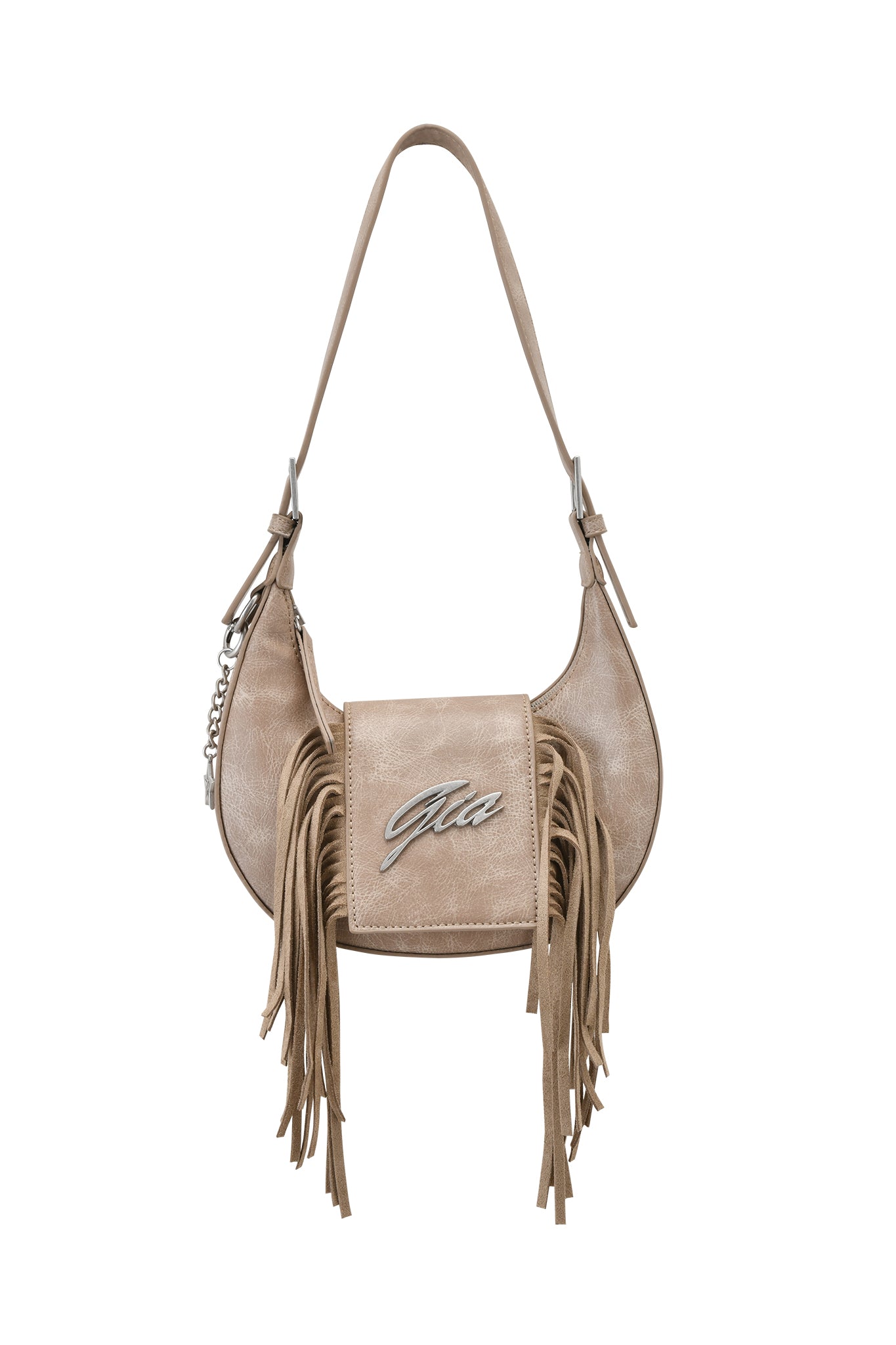 The I.AM.GIA TIA BAG in tan features faux leather, a flap closure, silver "Gia" logo, long fringe on the sides and front, plus a chain accent on the left strap.