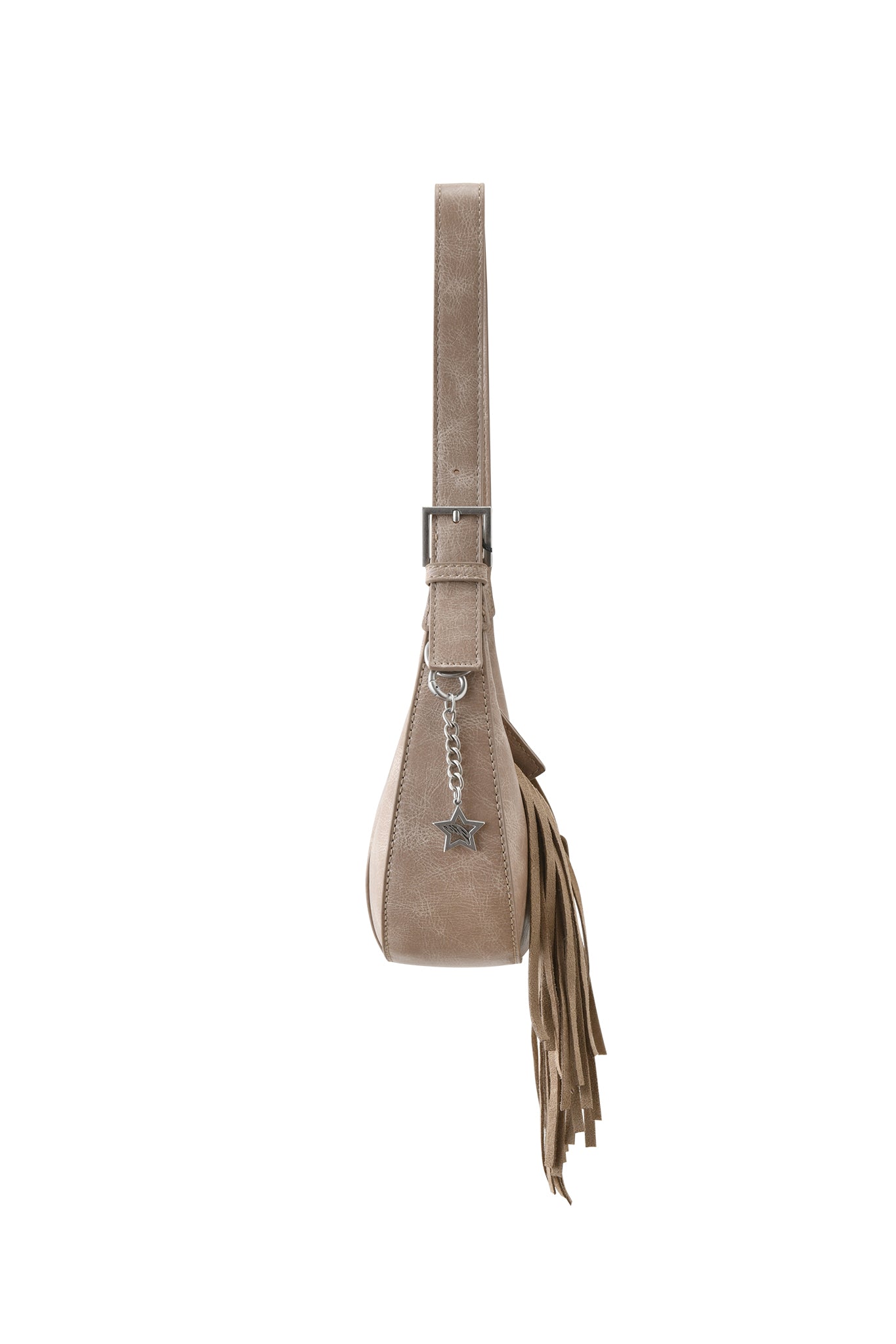 Side view of the TIA BAG - TAN FRINGE by I.AM.GIA, a beige faux leather shoulder purse with wide strap, silver buckle, star charm, and fringe detail on one side, shown against a white background.