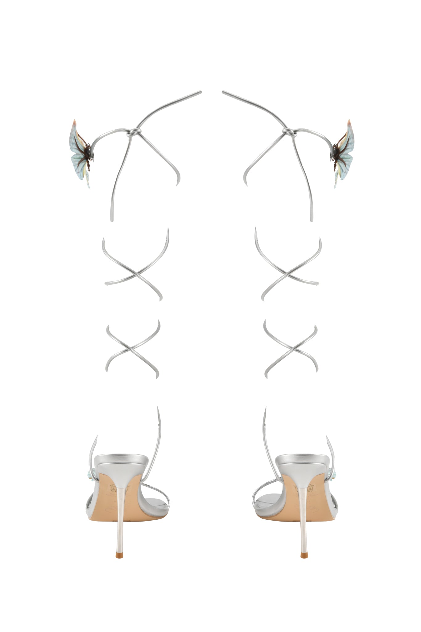 The SCARLETTE HEEL - SILVER by I.AM.GIA features metallic strappy heels with slim ankle straps and blue butterfly appliques on the back, displayed against a white background.